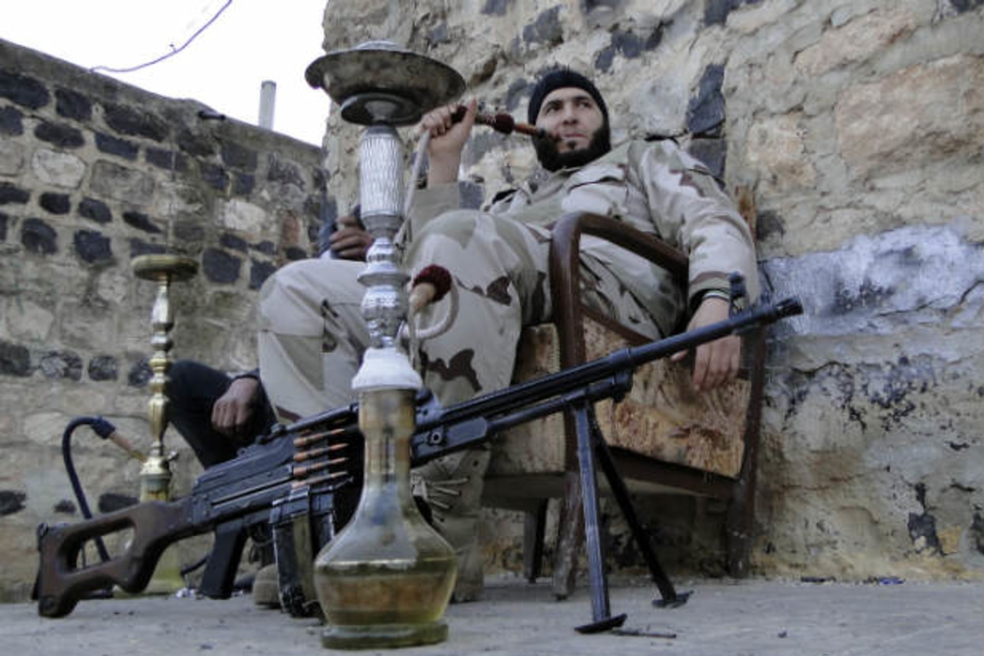 Free Syrian Army fighters smoke waterpipes near the Menagh military airport, in Aleppo's countryside January 25, 2013 (Hassano/Courtesy Reuters)..