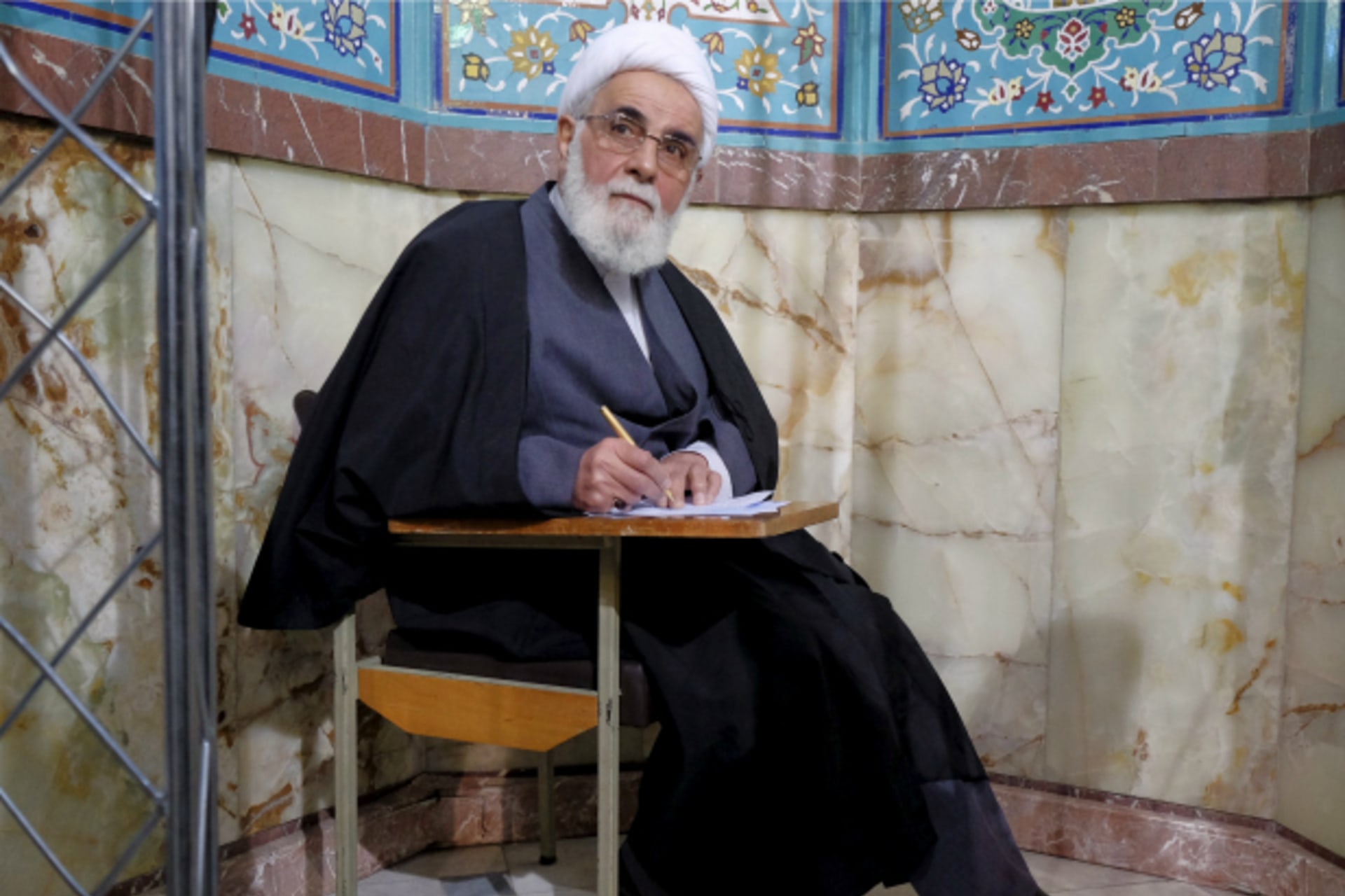 <p>Iran’s former Parliament speaker Ali Akbar Nateq-Nouri fills in his ballot during elections for the parliament and Assembly of Experts, which has the power to appoint and dismiss the supreme leader, in Tehran (Raheb Homavandi/Reuters).</p>
