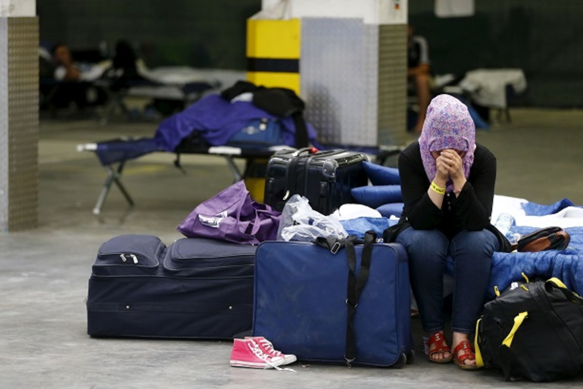 A Syrian woman cries as she sits in a  refugee registration center for the German state of Hesse in Neu-Isenburg, on the outskirts of Frankfurt, Germany, September 11, 2015. REUTERS/Kai Pfaffenbach
