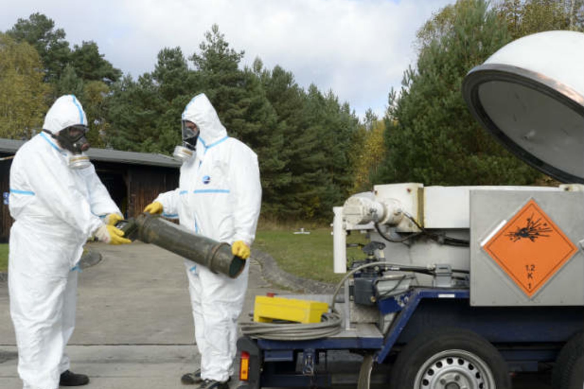 Workers dressed in protective clothes during a chemical weapons demonstration (Bimmer/Courtesy Reuters).