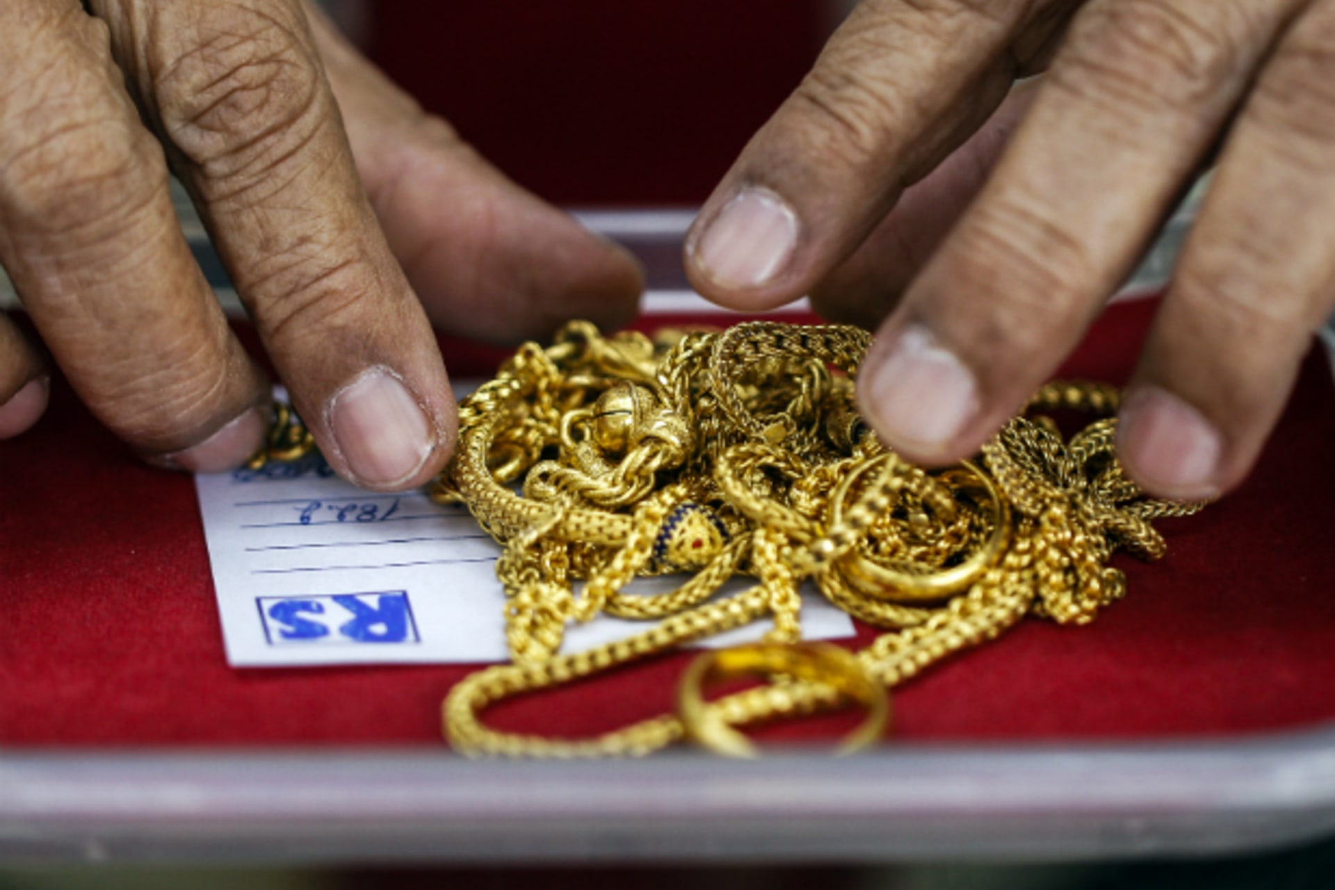 <p>A pawn shop worker sorts through gold jewellery at Easy Money Pawn shop in Bangkok on August 27, 2013. Faced with rising livin…onths, especially in areas near Bangkok, said Managing Director Sittiwit Tangthanakiat. (Athit Perawongmetha/Courtesy Reuters)</p>
