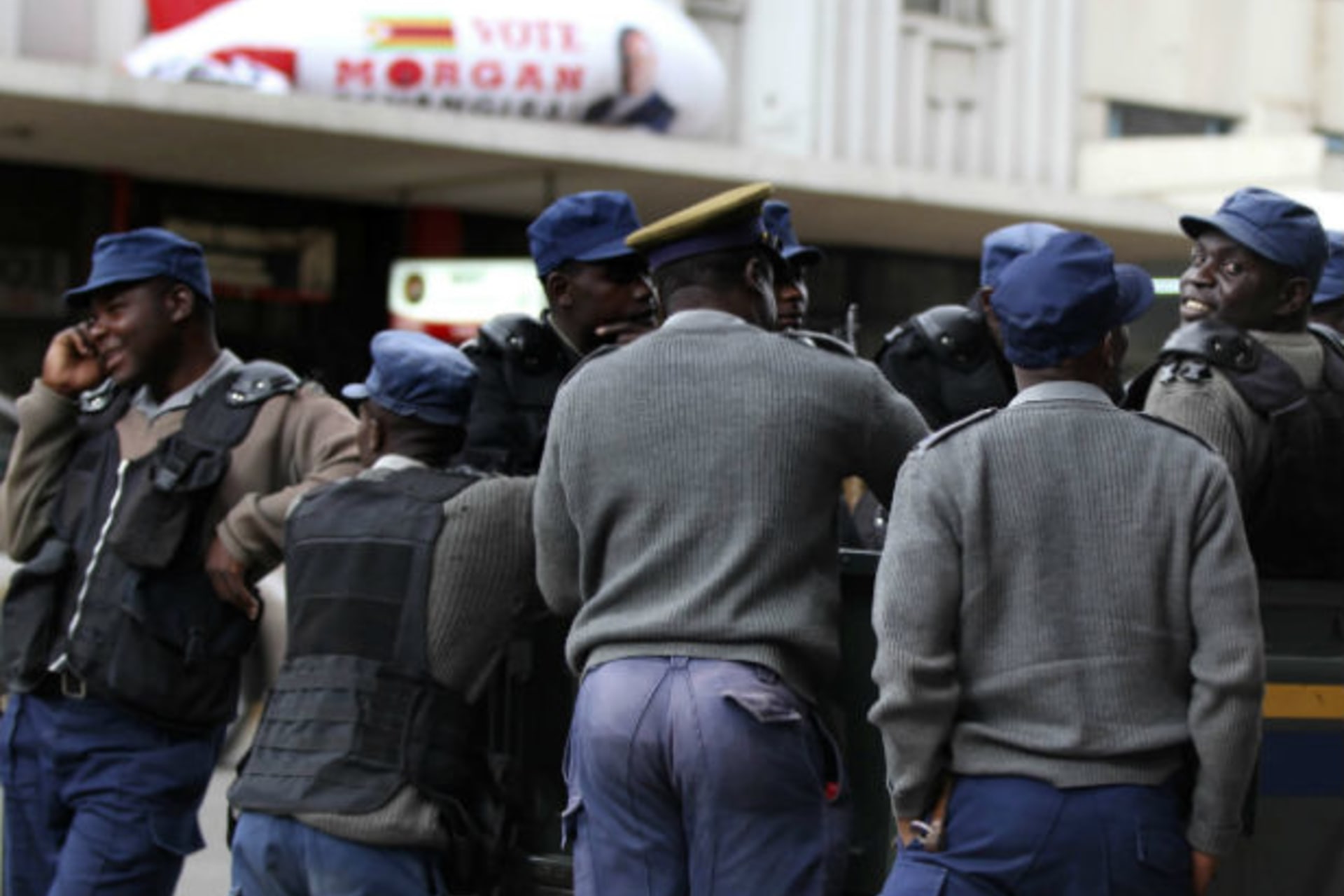 Zimbabwean police stand outside the opposition party Movement For Democratic Change (MDC) head offices in Harare August 1, 2013.