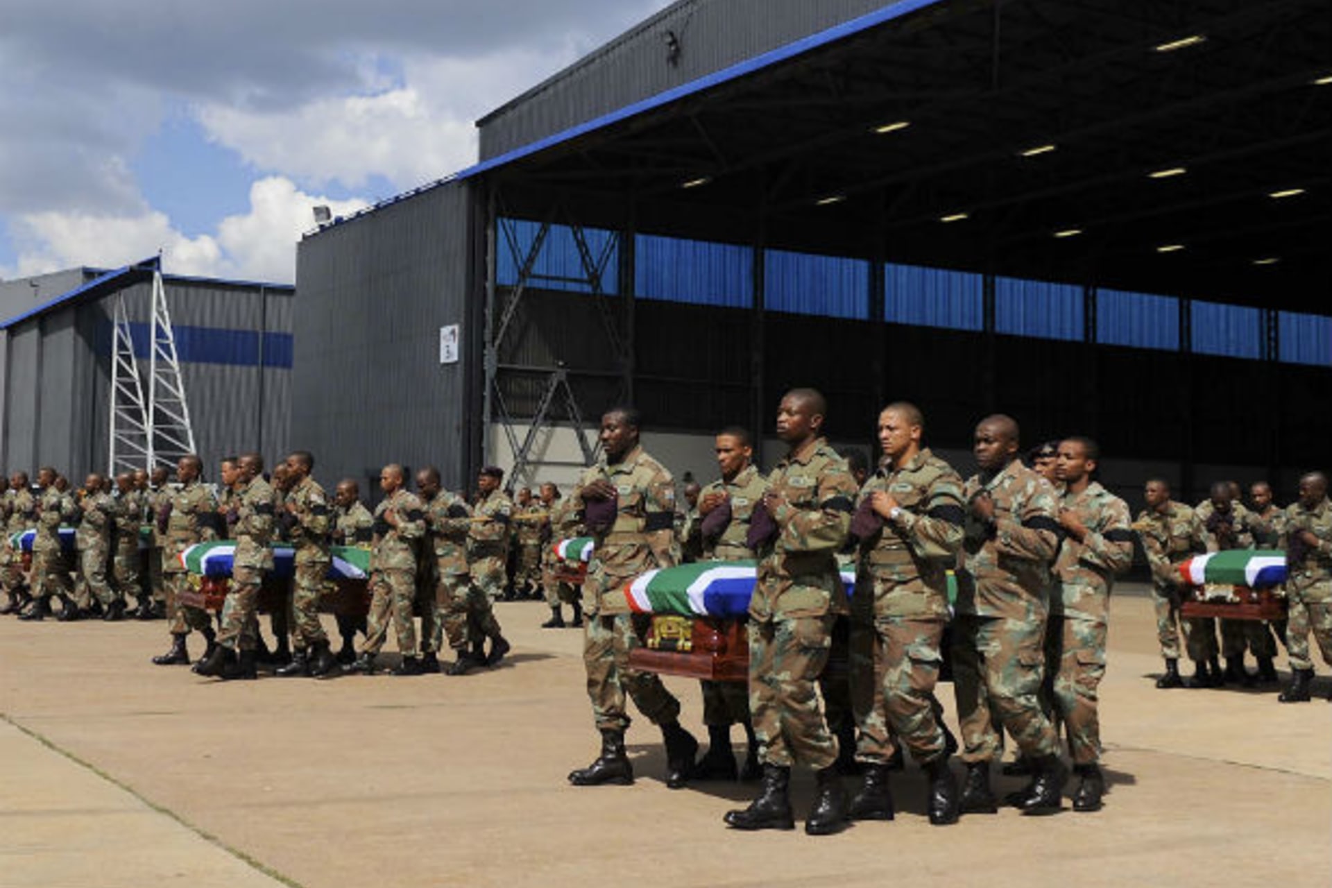 Members of the South Africa National Defence Force (SANDF) carry the mortal remains of 13 members that were killed in Central African Republic (CAR) during the handing over to the respective families at the Waterkloof Air Force Base, in Pretori