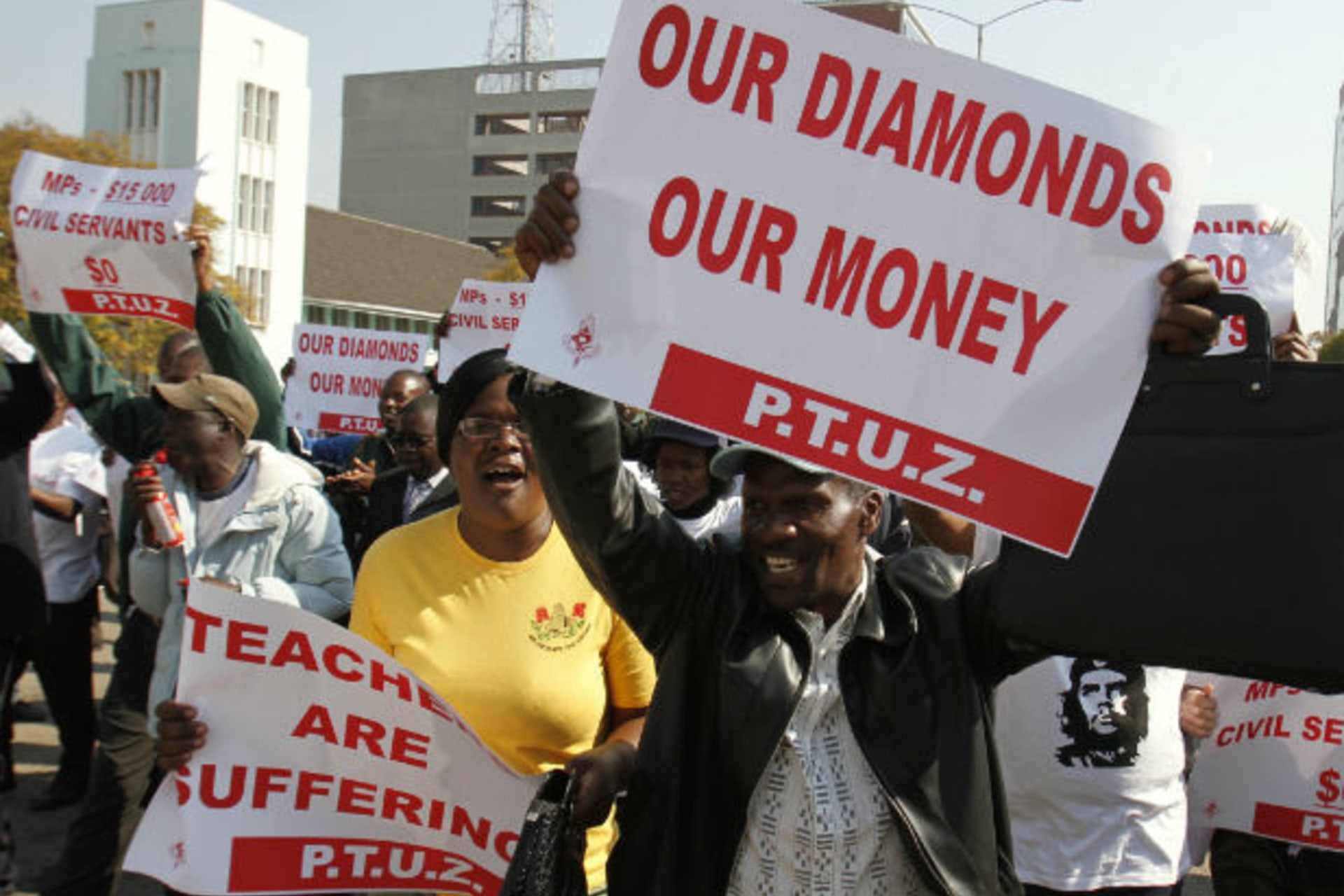 Zimbabwe's civil servants sing and dance during their march to the Finance Minister's office and the Parliament for their salary raise in Harare, July 24, 2012.