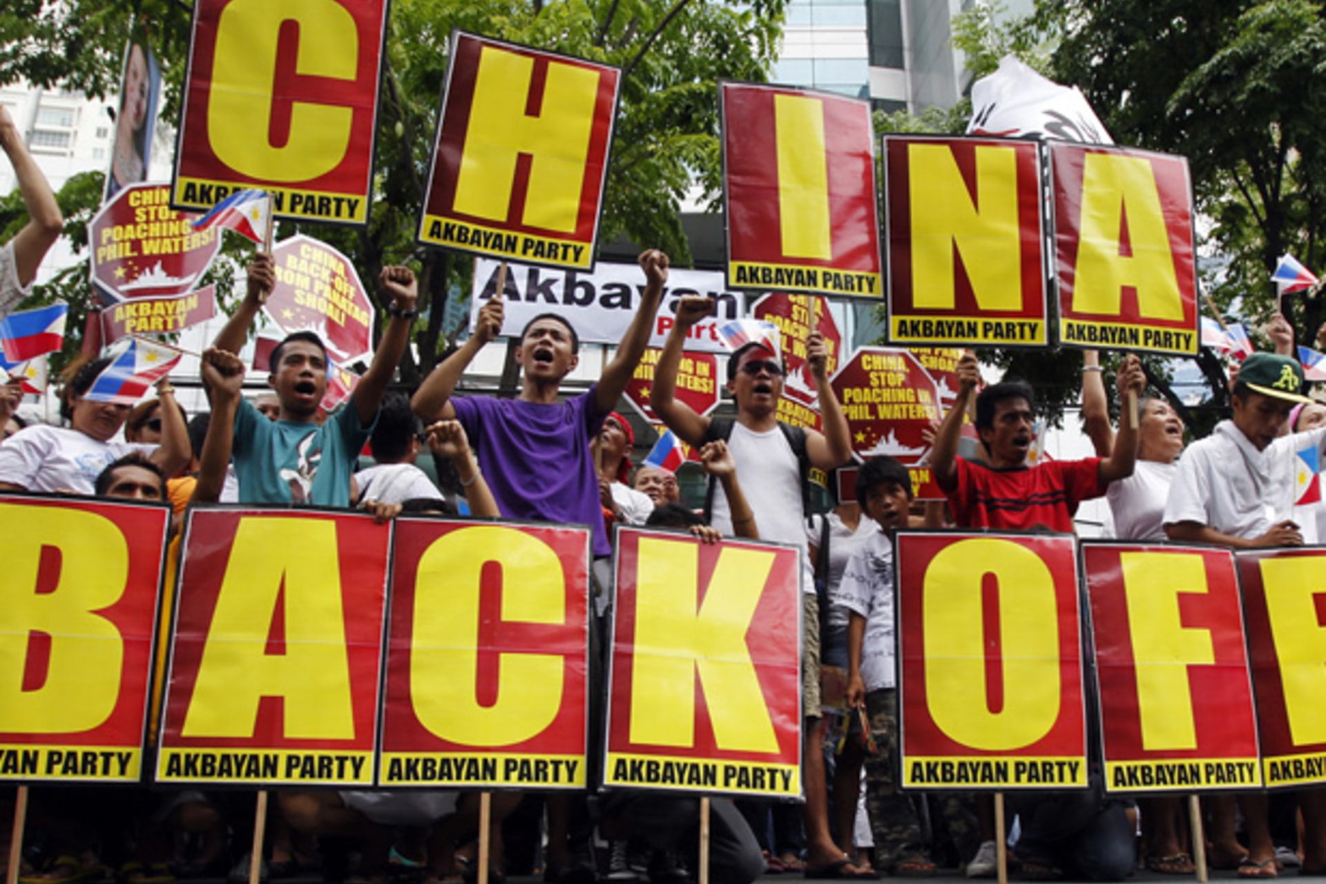 Filipino protesters shout anti-China slogans while holding placards during a demonstration outside the Chinese consulate in Manila