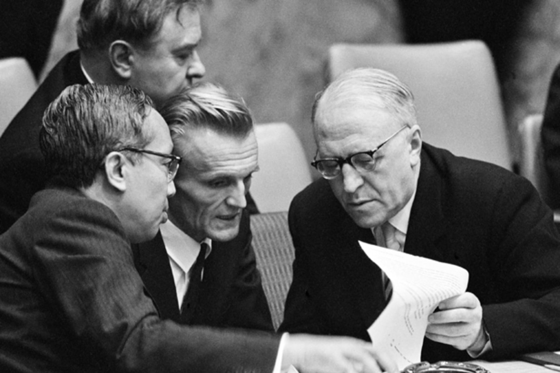 <p>Acting UN secretary general U Thant and Soviet ambassador to the UN Valerian A. Zorin discuss a document through an interpreter at the UN Security Council on October 24, 1962. (UN Photo/Yutaka Nagata)</p>