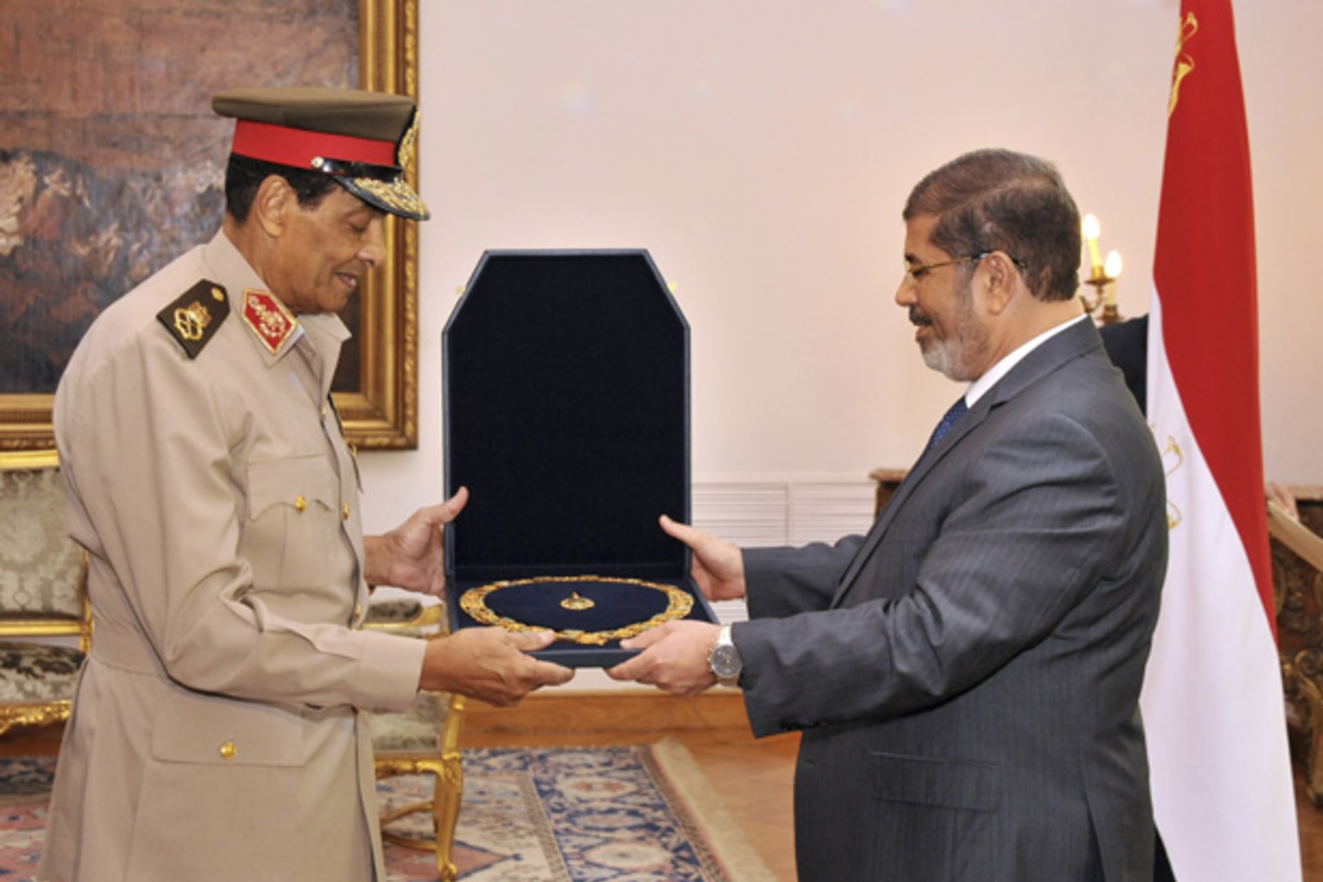 <p>Former Egyptian defense minister Field Marshal Hussein Tantawi receives a medal from Egyptian president Mohammed Morsi at the Presidential Palace in Cairo. (Egyptian Presidency/Handout/courtesy Reuters)</p>
