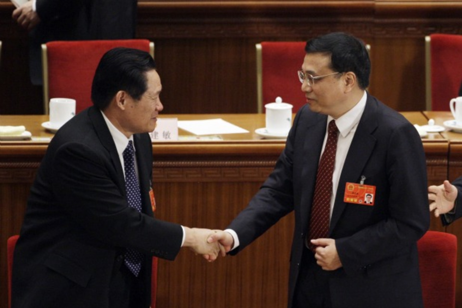 <p>Li Keqiang, right, shakes hands with China’s Politburo Standing Committee Member Zhou Yongkang after Li was elected Vice Premier in Beijing on March 17, 2008.</p>
