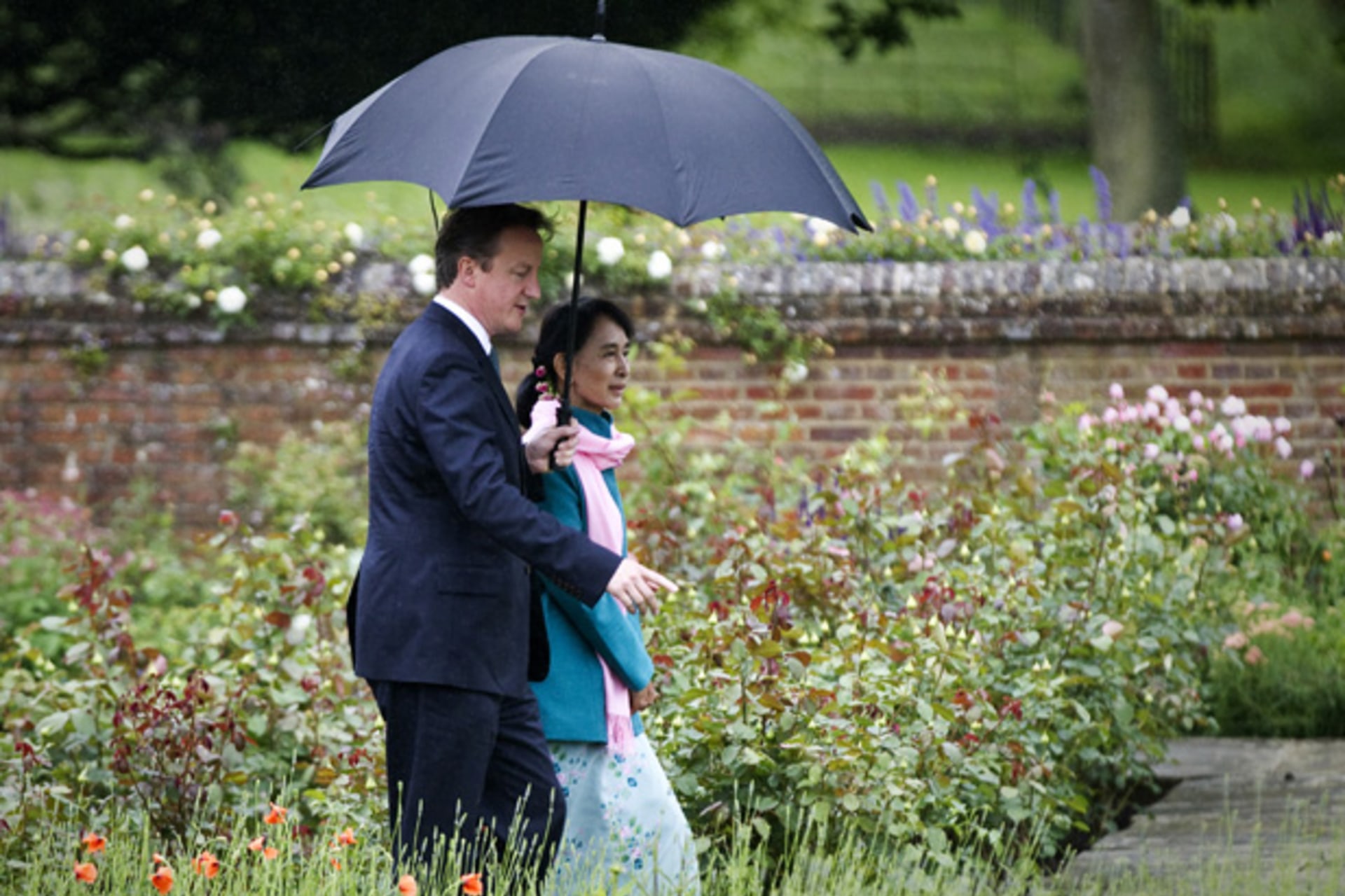 <p>Britain’s Prime Minister David Cameron and Myanmar pro-democracy leader Aung San Suu Kyi walk in the rose garden at Chequers, the Prime Minister’s official country residence in Buckinghamshire, southern England June 22, 2012.</p>
