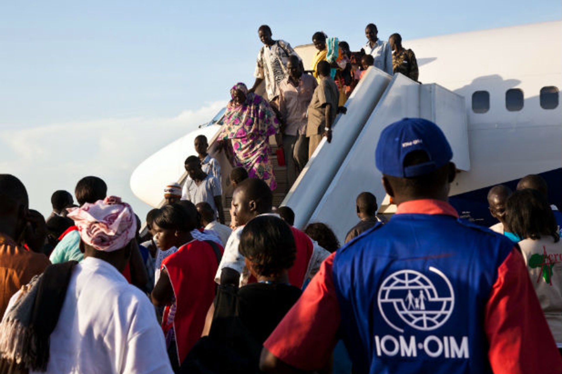 South Sudanese returnees from Khartoum disembark from a plane as they arrive in South Sudan's capital Juba