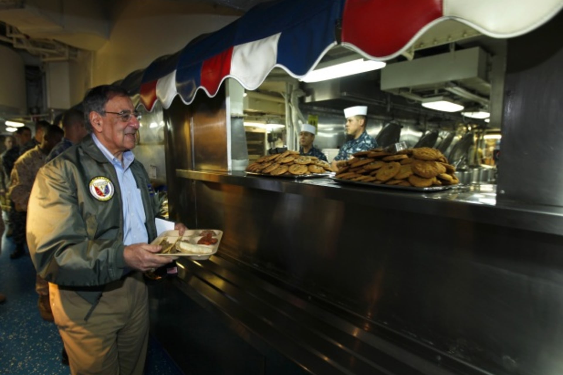 <p>U.S. Secretary of Defense Leon Panetta gets his lunch aboard the USS Peleliu (Courtesy Reuters/Mike Blake).</p>