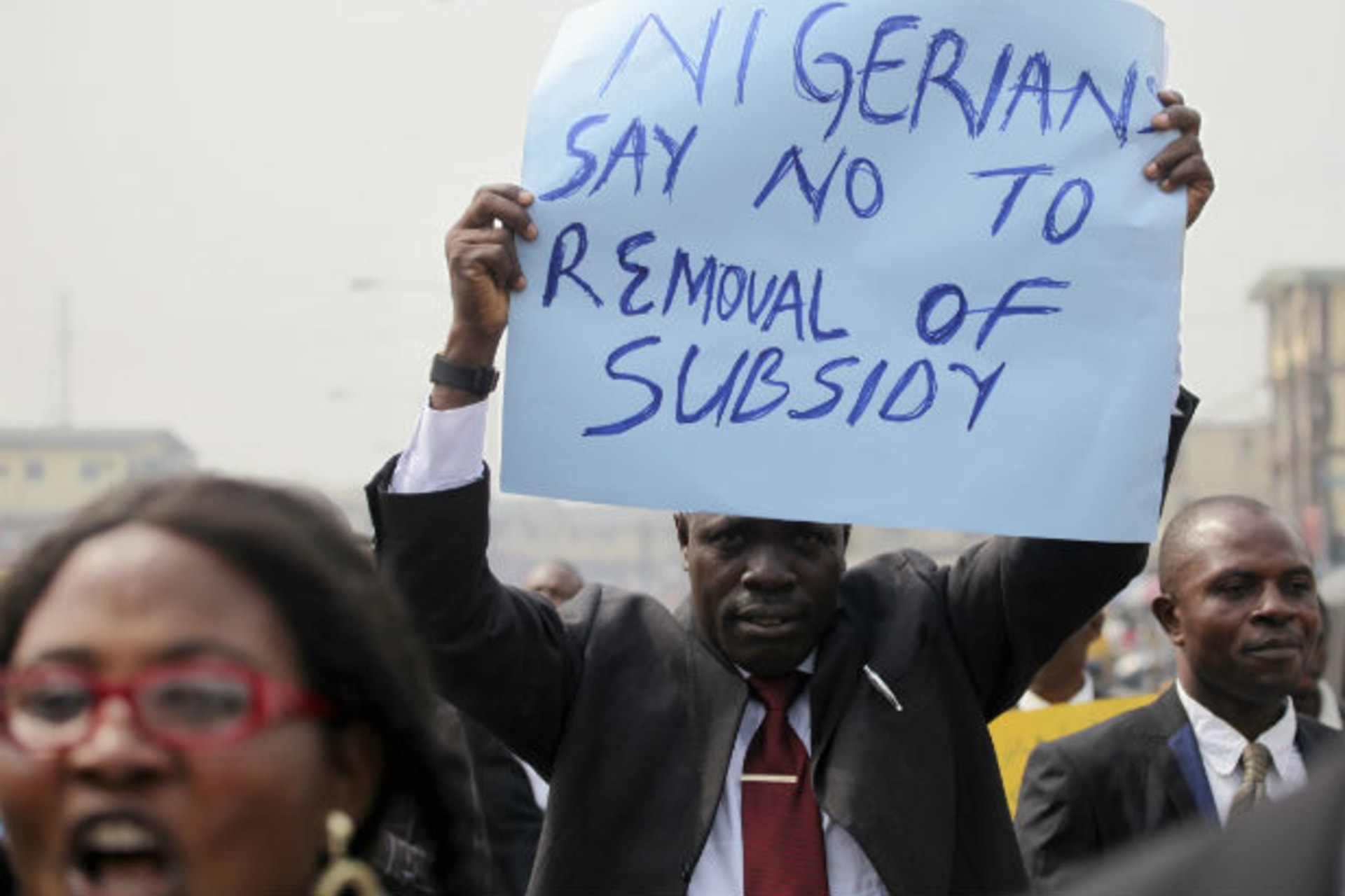 A member of the Nigerian Bar Association holds up a placard to protest a fuel subsidy removal in Lagos January 5, 2012.