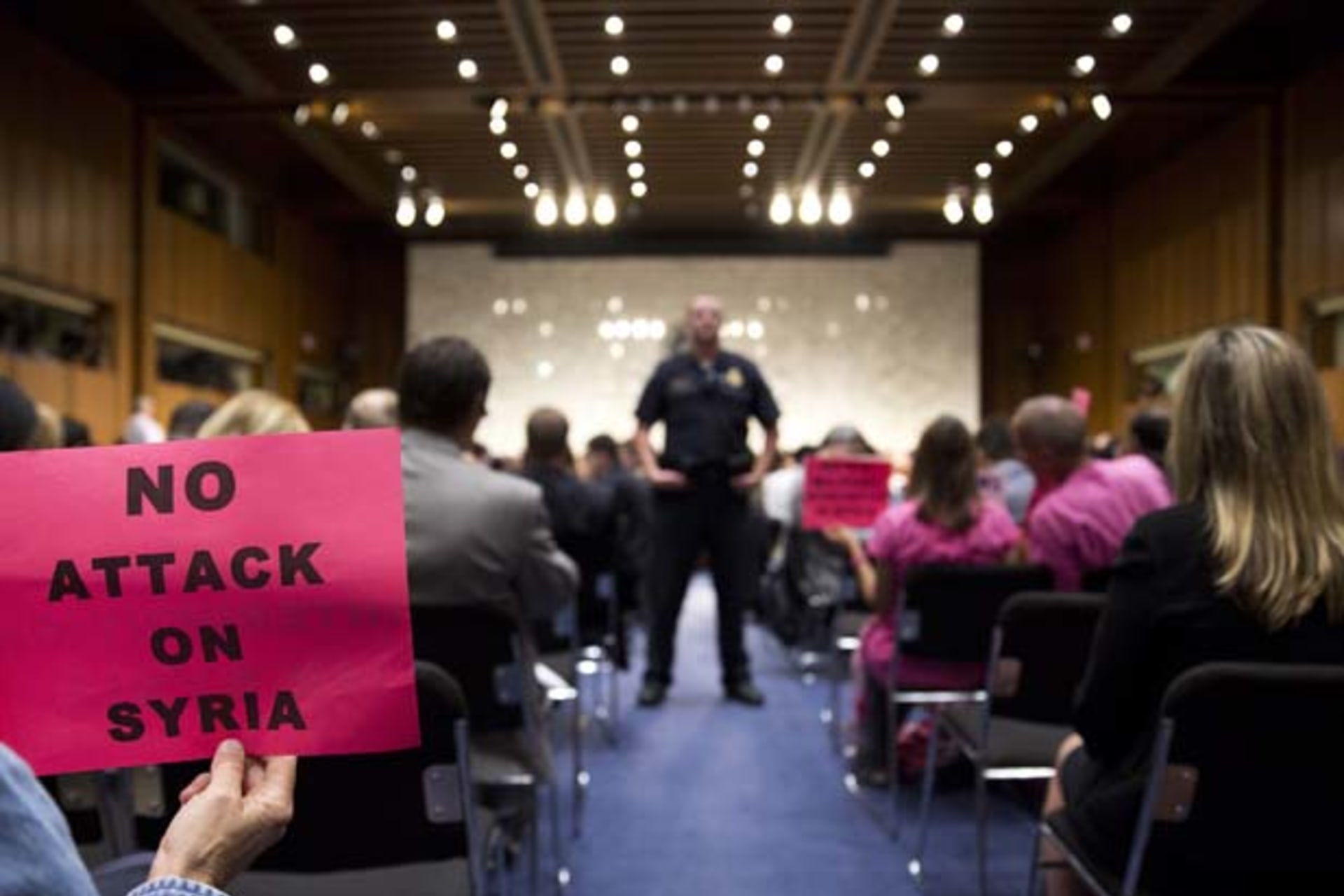 <p>A protester holds up a sign against U.S. action in Syria as Chairman of the Joint Chiefs General Martin E. Dempsey, Secretary … and Secretary of Defense Chuck Hagel testify before the Senate Foreign Relations Committee (Joshua Roberts/Courtesy Reuters).</p>