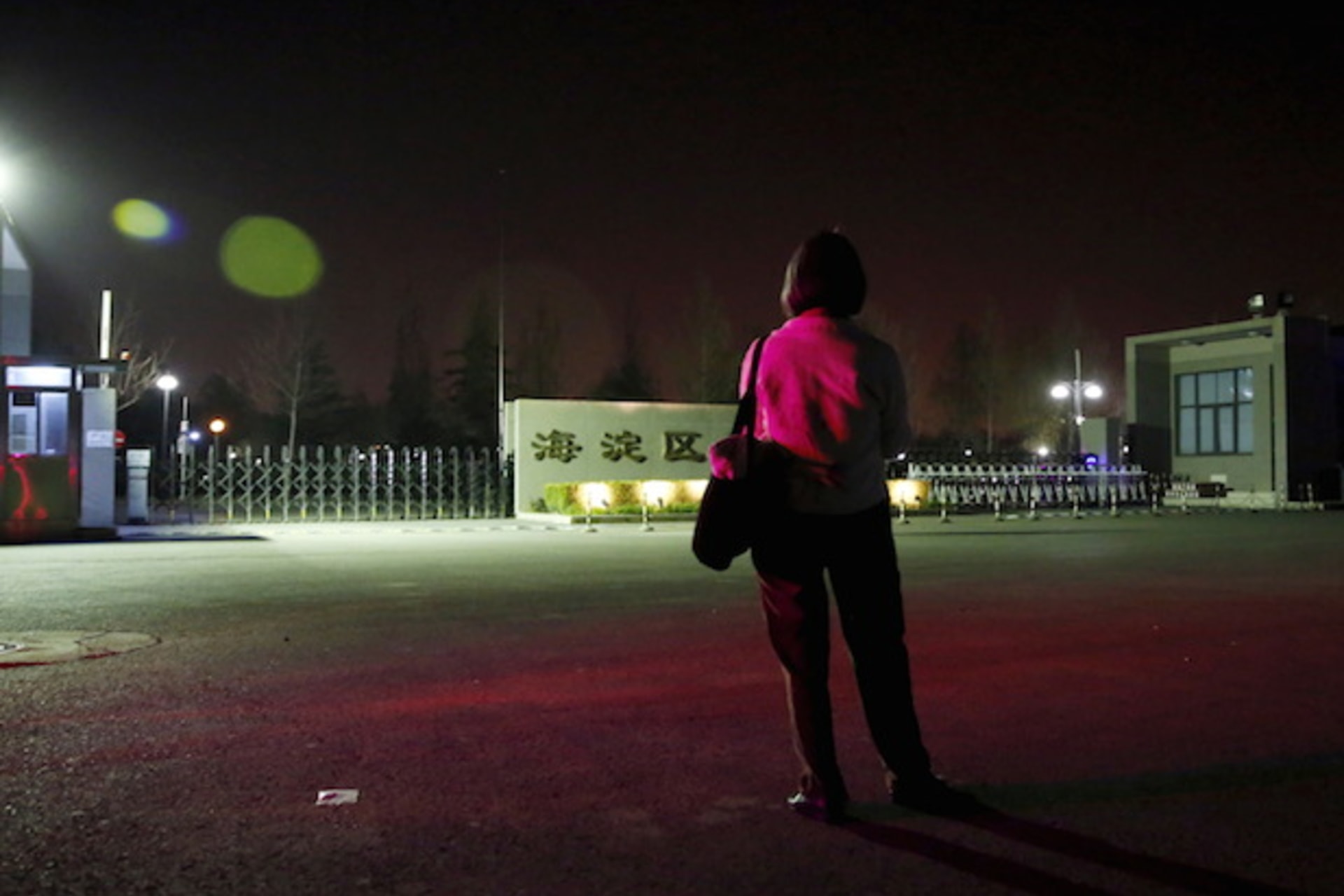 Women's rights activist Feng Yuan waits for the release of detained women activists in front of a detention center in Beijing