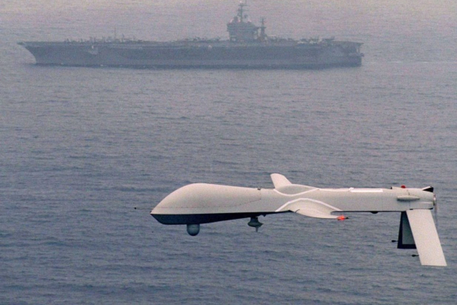 <p>File photo of a Predator drone flying above the USS Carl Vinson (Courtesy Reuters/Handout).</p>