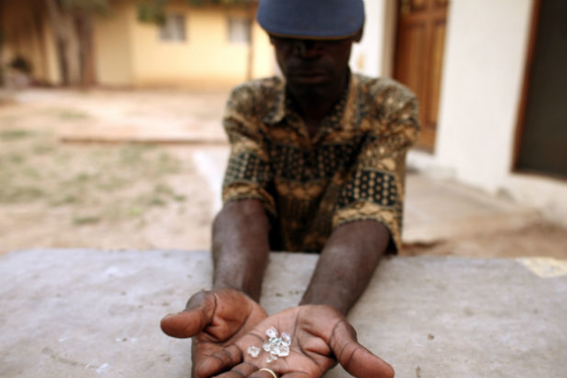 An illegal diamond dealer from Zimbabwe displays diamonds for sale in Manica, near the border with Zimbabwe, September 19, 2010.