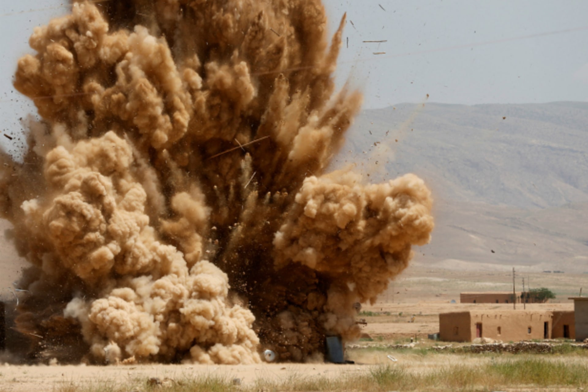 <p>Members of the Sinjar Resistance Units (YBS), a militia affiliated with the Kurdistan Workers’ Party (PKK), detonate improvised explosive devices captured from Islamic State fighters near village of Umm al-Dhiban, northern Iraq (Goran Tomasevic/Reuters).</p>
