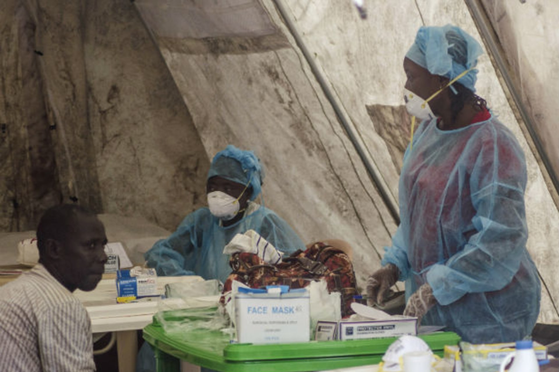 <p>Health workers screen patients for the Ebola virus at a local government hospital in Kenema, Sierra Leone, on June 30, 2014.</p>