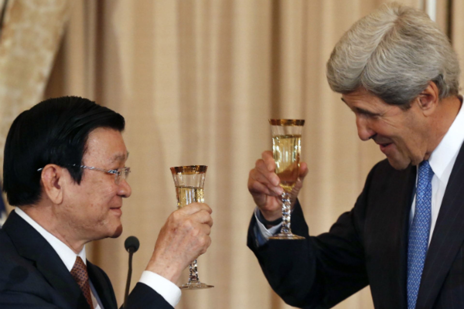 <p>U.S. Secretary of State John Kerry offers a toast with Vietnam’s President Truong Tan Sang before a luncheon at the U.S. State Department in Washington on July 24, 2013. (Larry Downing/Courtesy Reuters)</p>
