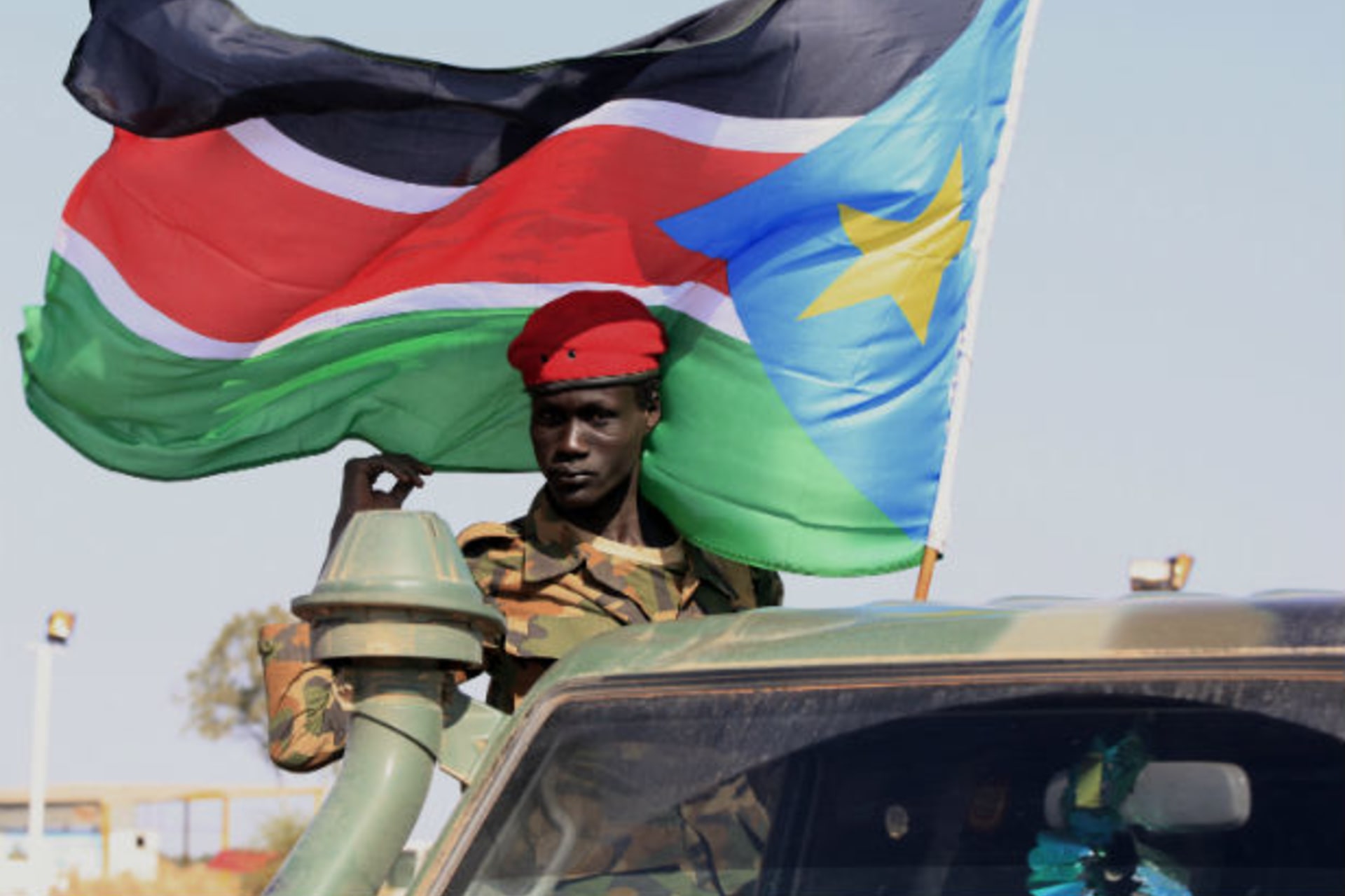 An SPLA soldier stands on the back of a pick-up truck in Bentiu, Unity state January 12, 2014.