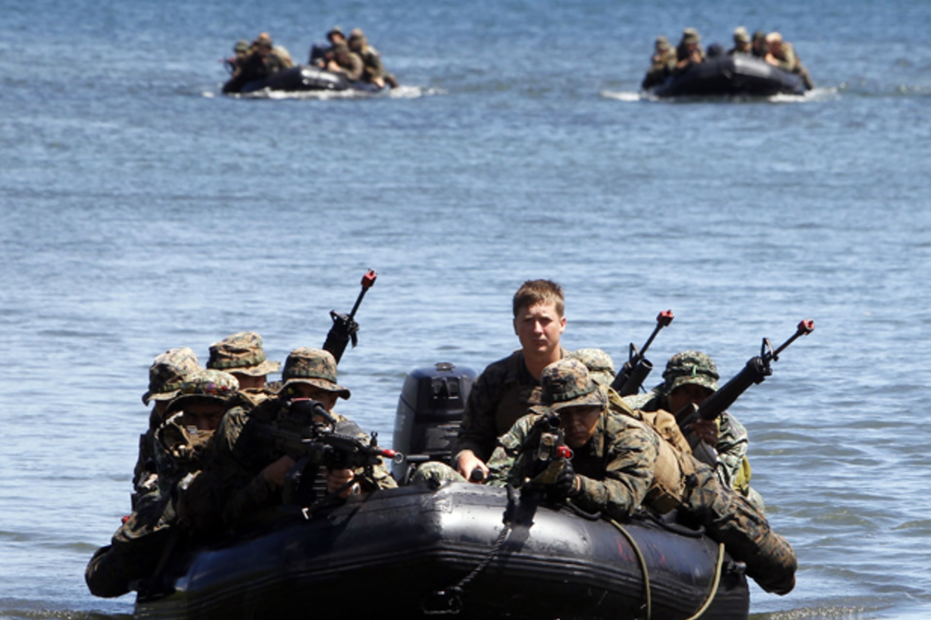 Philippine and U.S. marines sit in rubber dinghies during an amphibious raid as part of a Philippine-U.S. joint military exercise in Ulugan bay