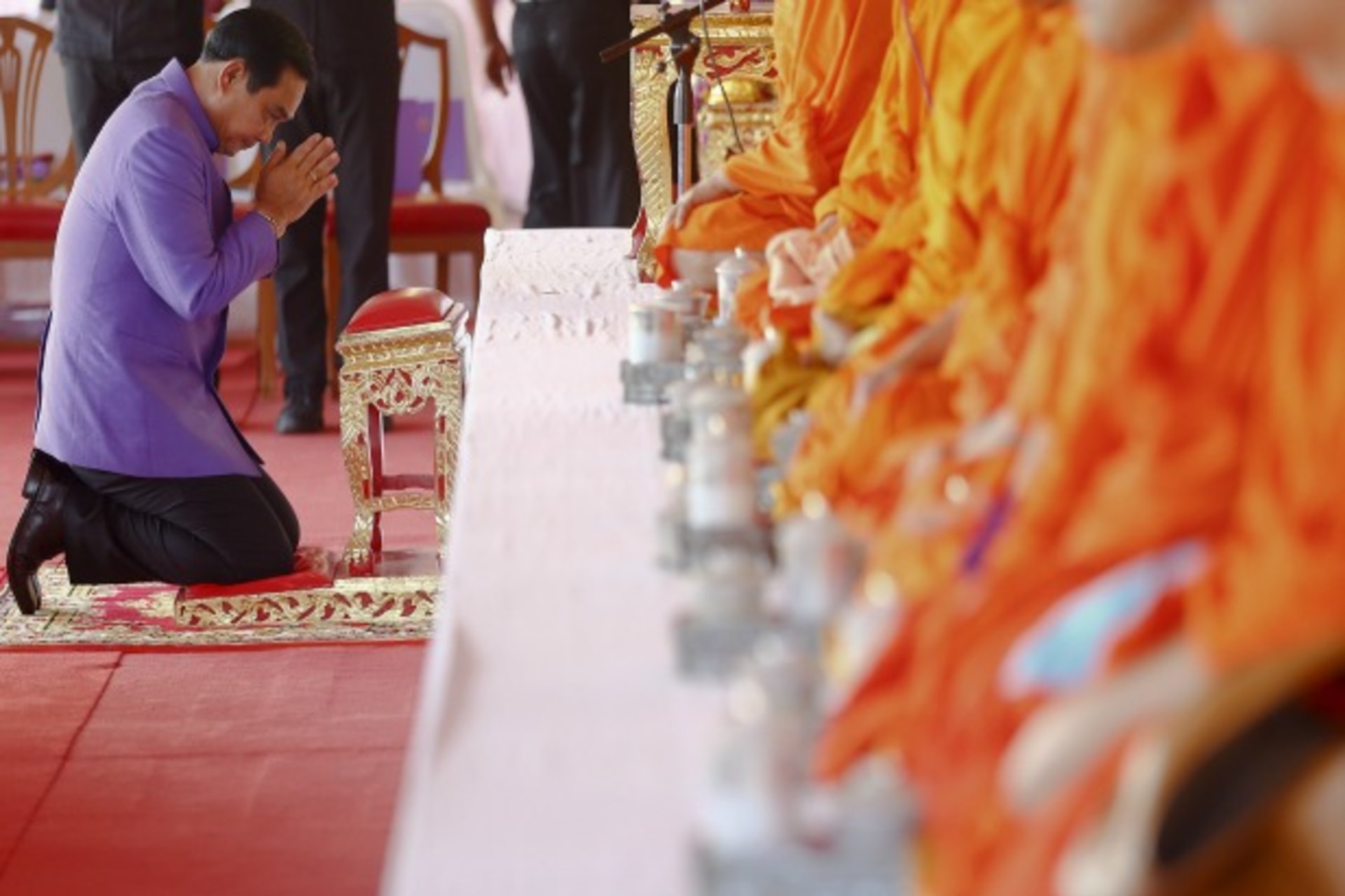 <p>Thailand’s Prime Minister Prayuth Chan-ocha prays as he takes a part in the merit-making ceremony on the occasion of Princess Maha Chakri Sirindhorn’s birthday at Sanam Luang in Bangkok on April 2, 2015. (Damir Sagolj/Courtesy: Reuters)</p>
