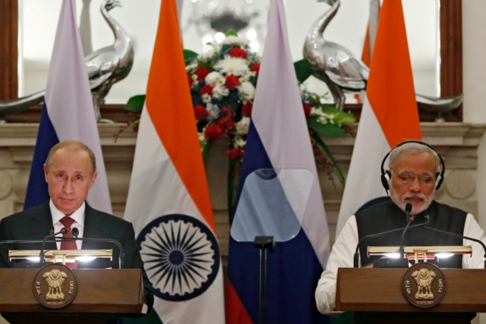 <p>Russian President Vladimir Putin (L) reads a joint statement as Indian Prime Minister Narendra Modi watches after their delegation level talks at Hyderabad House in New Delhi on December 11, 2014. (Adnan Abidi/Courtesy Reuters)</p>
