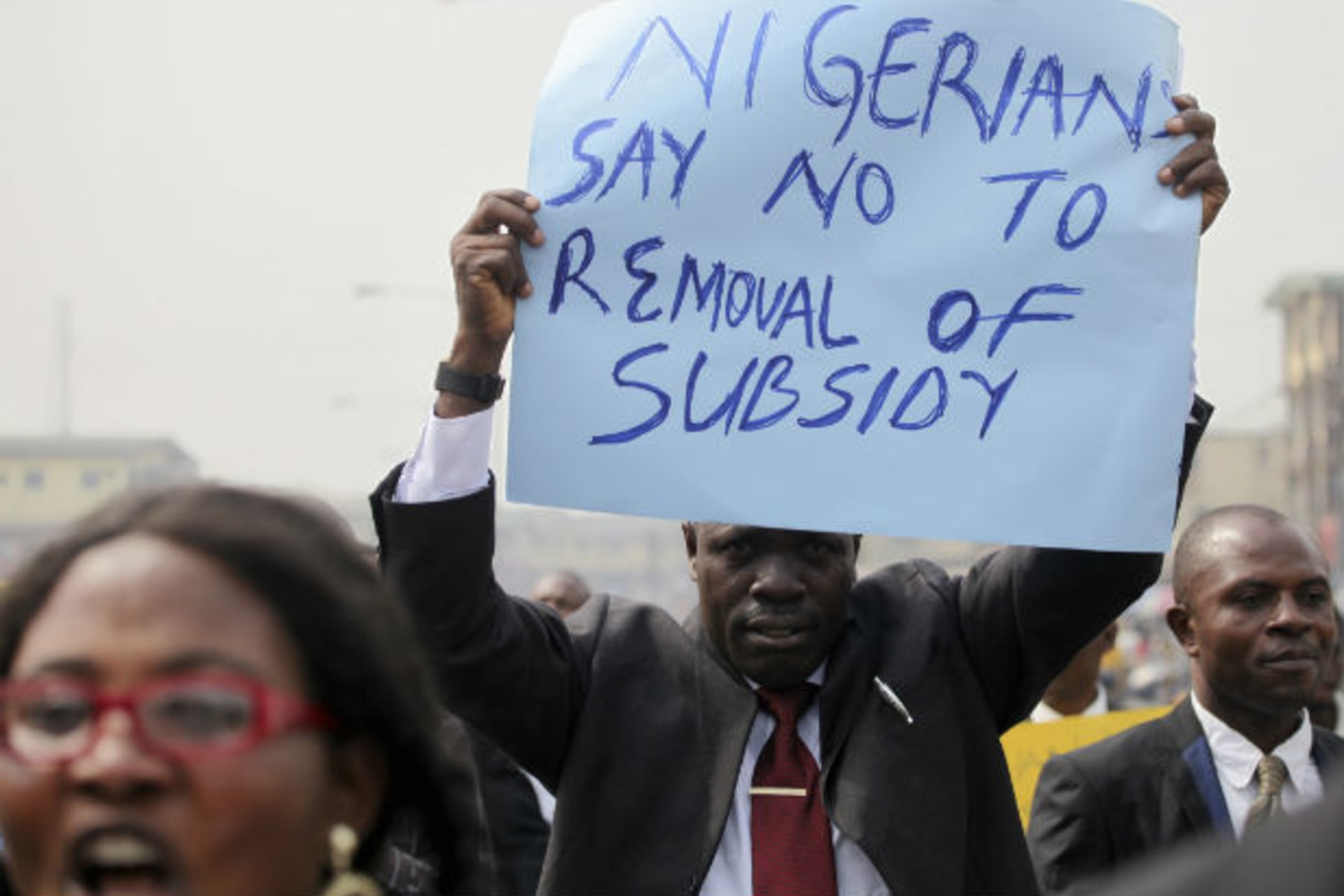 A member of the Nigerian Bar Association holds up a placard to protest a fuel subsidy removal in Lagos January 5, 2012.