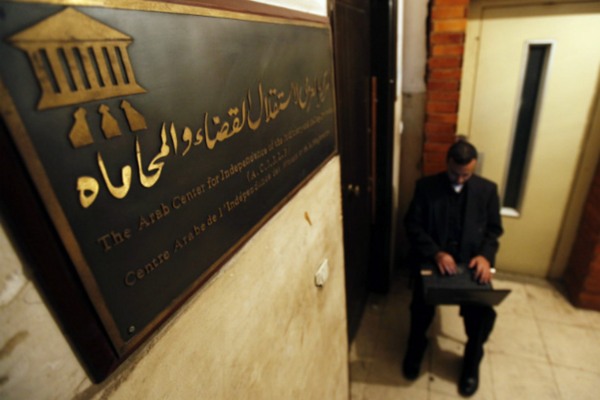 <p>An Egyptian human rights worker sits outside a non-governmental organization in Cairo. (Courtesy Reuters)</p>
