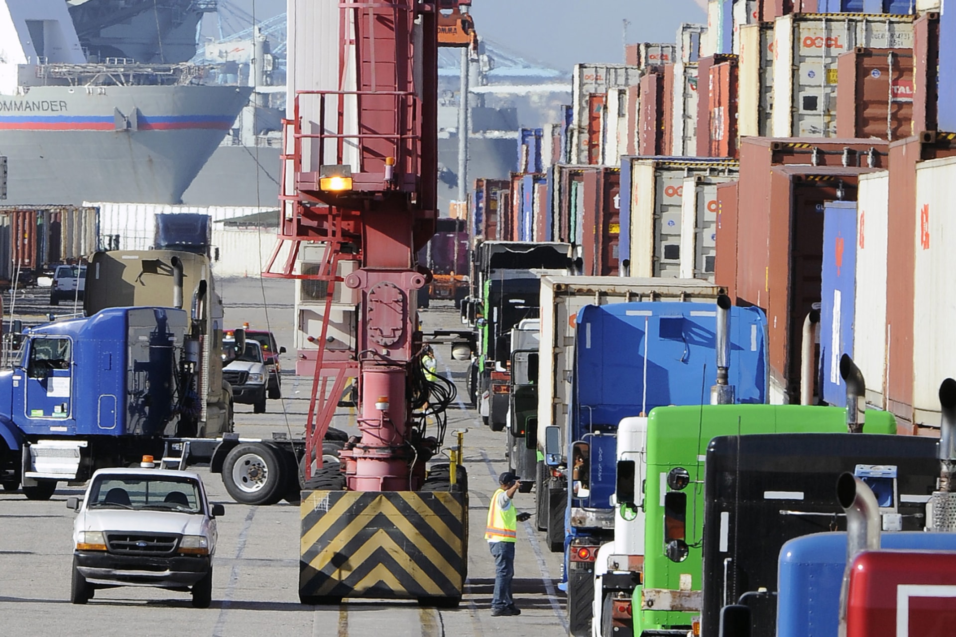 <p>Semi trucks line up to pick up shipping containers at the Port of Long Beach on October 27, 2014.</p>