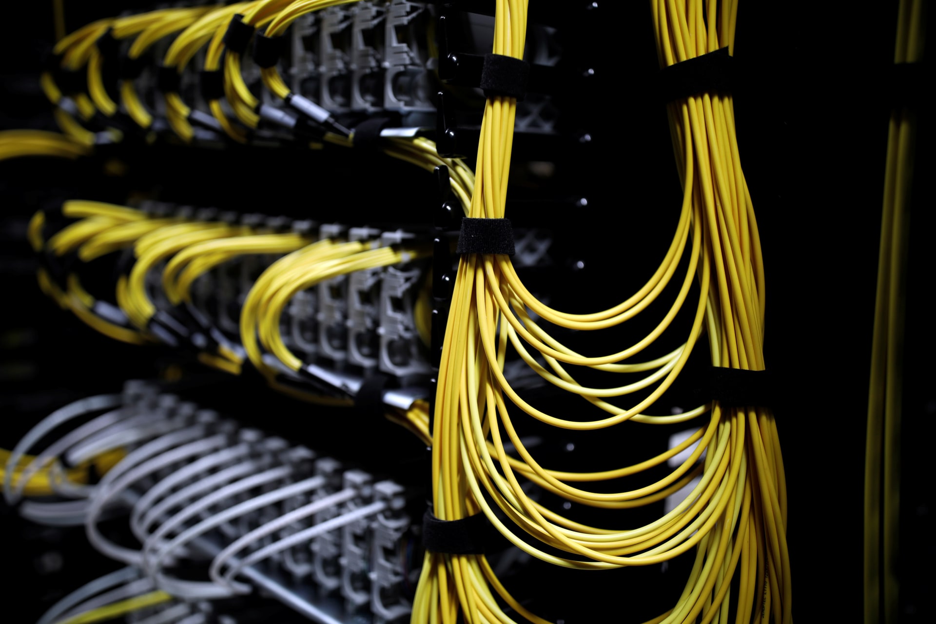 <p>Cables run into the back of a server unit inside an Equinix data center outside Paris, on December 7, 2016.</p>