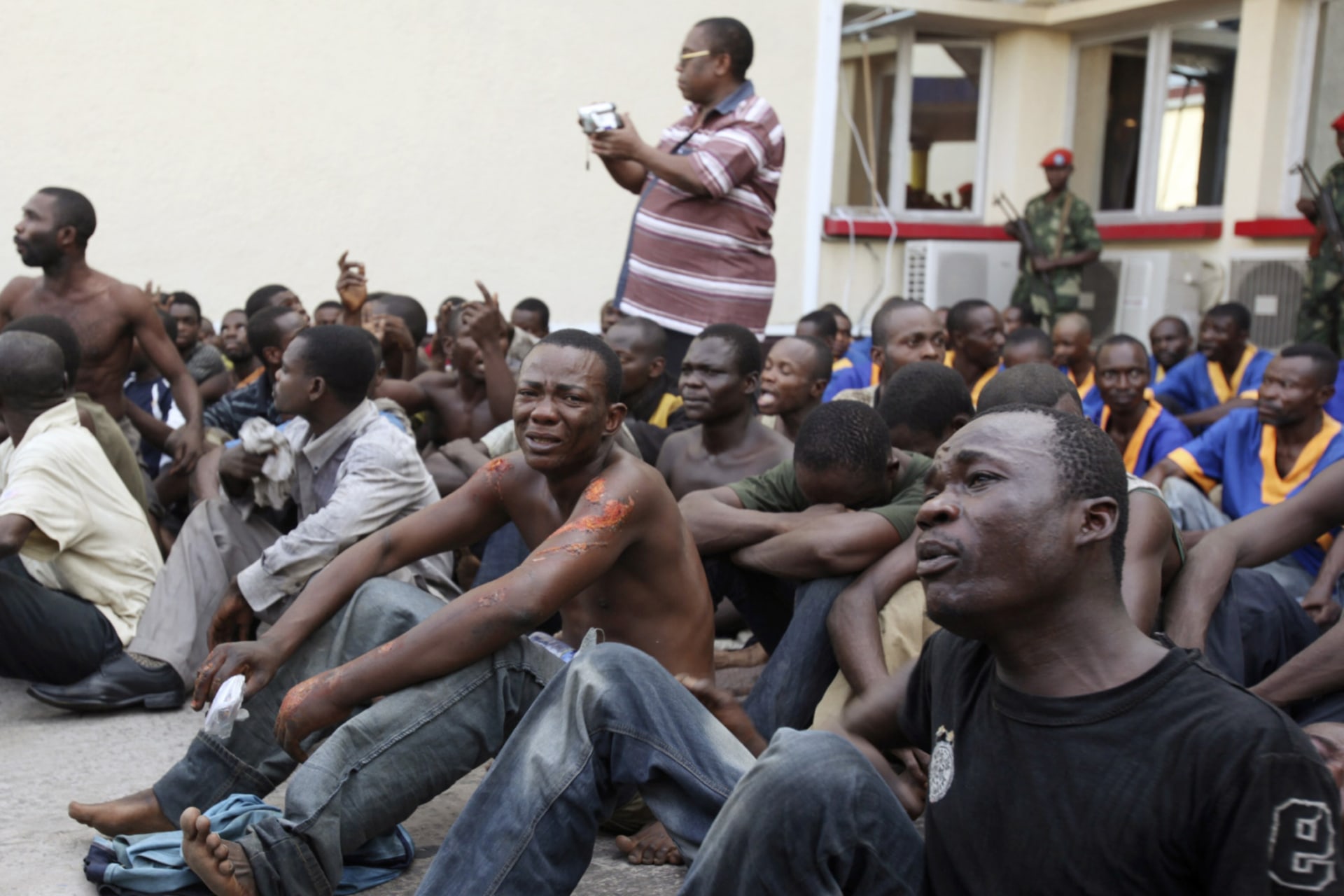 <p>More than 100 people, whom authorities arrested for what they say are their links to a thwarted attack on President Joseph Kabila’s residence, are displayed to the media in Kinshasa on March 7, 2011.</p>
