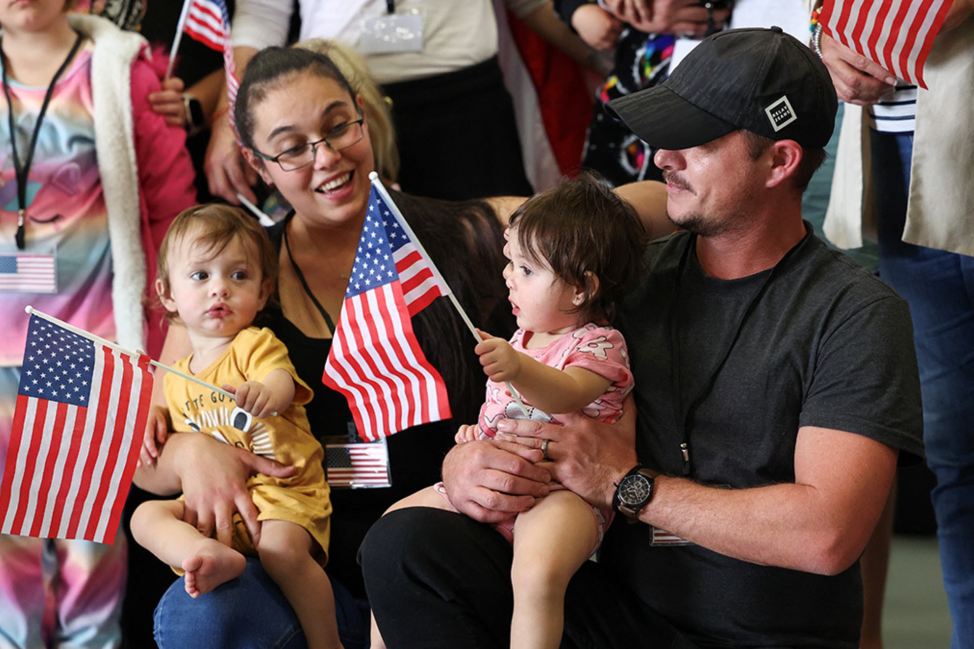 <p>White South Africans granted refugee status for being deemed victims of racial discrimination under U.S. President Trump’s Refugee plan, hold U.S. flags at Dulles International Airport, in Dulles, Virginia, U.S., May 12, 2025.</p>