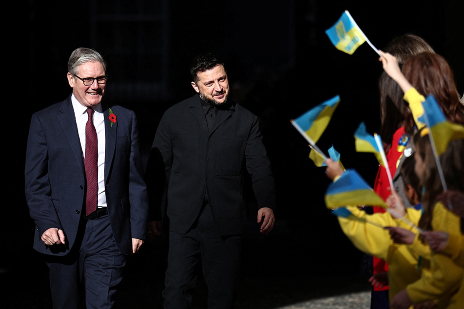 <p>British Prime Minister Keir Starmer and Ukrainian President Zelenskyy are greeted by Ukranian school children as they arrive  for a meeting of the Coalition of the Willing, in London, Britain, October 24, 2025.</p>
