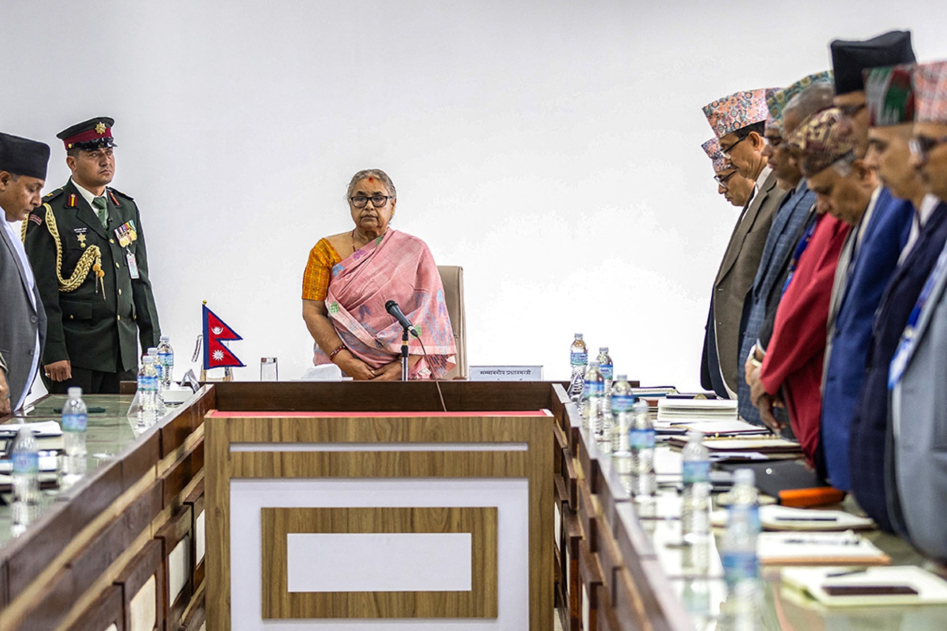 <p>Newly-elected Prime Minister of Nepal’s interim government Sushila Karki (C), along with officials, observes a moment of silence to pay her tribute to those who lost their lives in recent protests in Kathmandu on September 14, 2025.</p>
