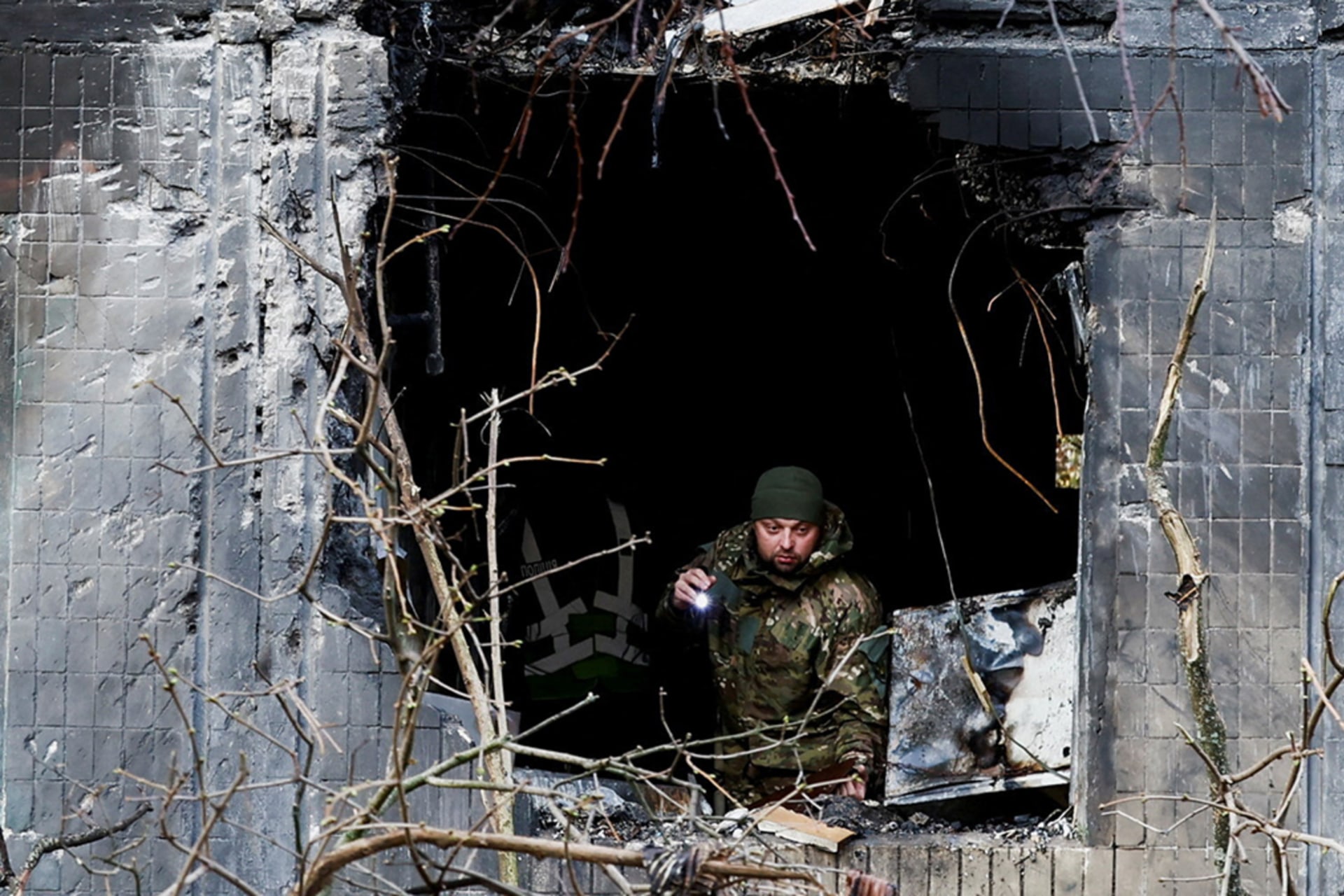 <p>An investigator looks through the window of an apartment building damaged during an overnight Russian drone and missile strike, amid Russia’s attack on Ukraine, in Kyiv, Ukraine, November 14, 2025. </p>
