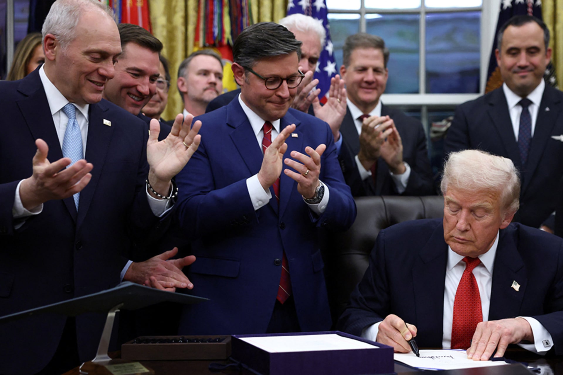 <p>U.S. President Donald Trump signs the funding bill to end the U.S. government shutdown, at the White House in Washington, D.C., U.S., November 12, 2025. </p>
