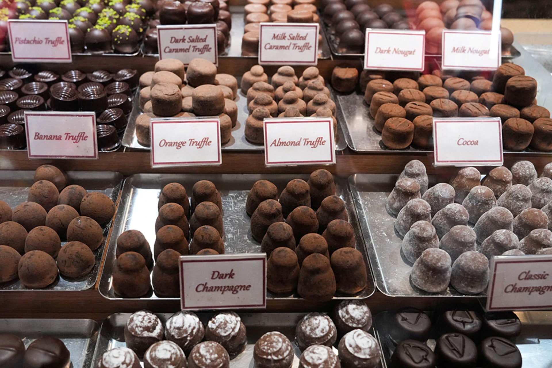 <p>Chocolates are displayed in a Teuscher Chocolates of Switzerland store on Fifth Avenue as President Trump’s new tariffs are imposed, in New York City, U.S., August 7, 2025.</p>