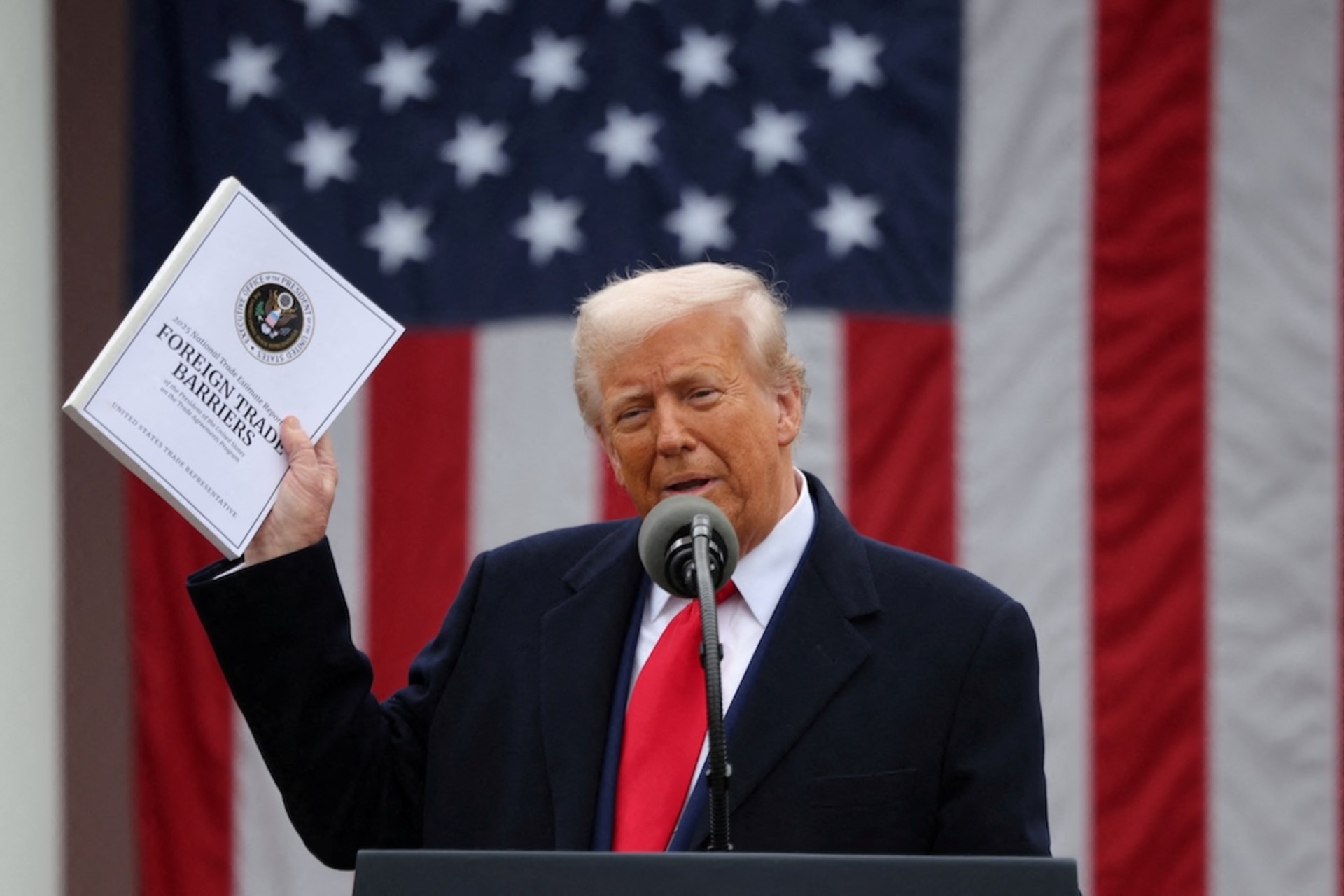 <p>U.S. President Donald Trump holds a “Foreign Trade Barriers” document as he delivers remarks on tariffs in the Rose Garden at the White House in Washington, D.C., U.S., April 2, 2025. </p>