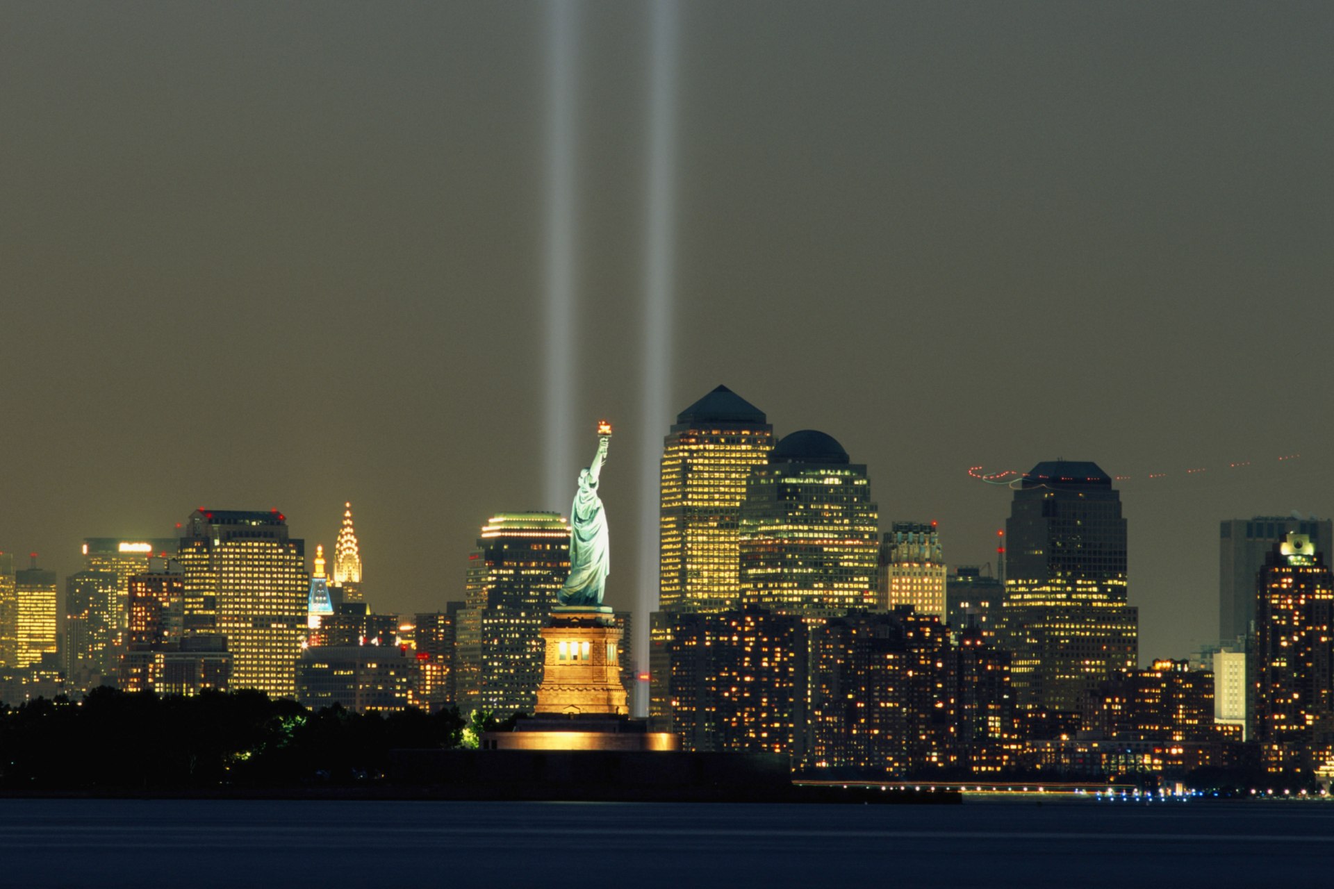 <p>9/11 memorial lights over New York City skyline.</p>

