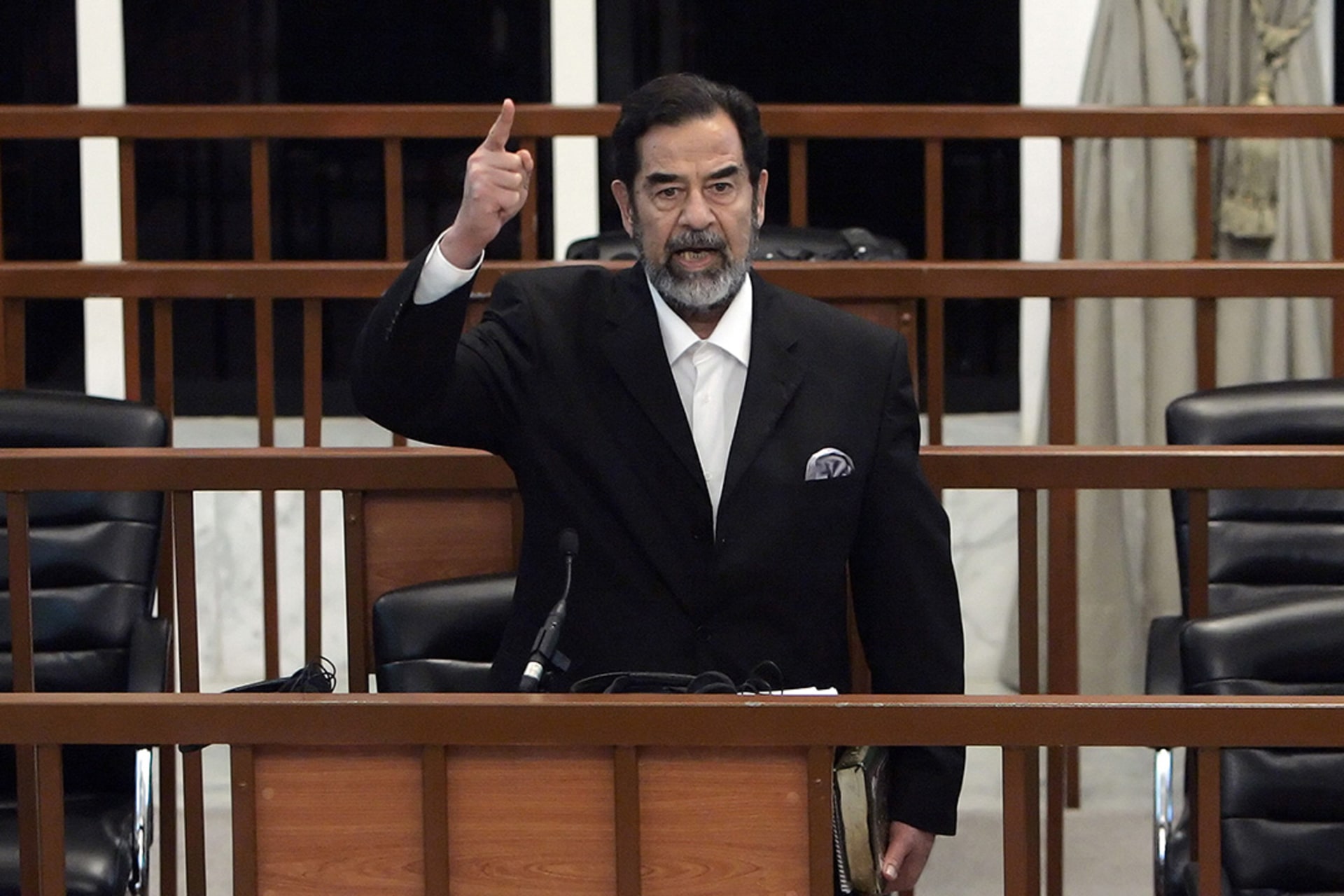 Saddam Hussein shouts at the courtoom while the verdict is read during his trial.