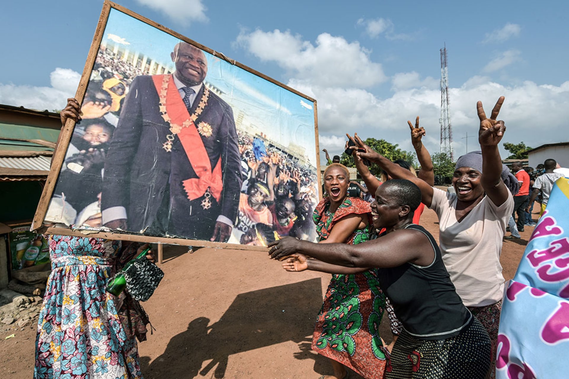 People holding a portrait of former Ivorian President Laurent Gbagbo celebrate in his birthplace of Gagnoa after receiving news of his acquittal. 
