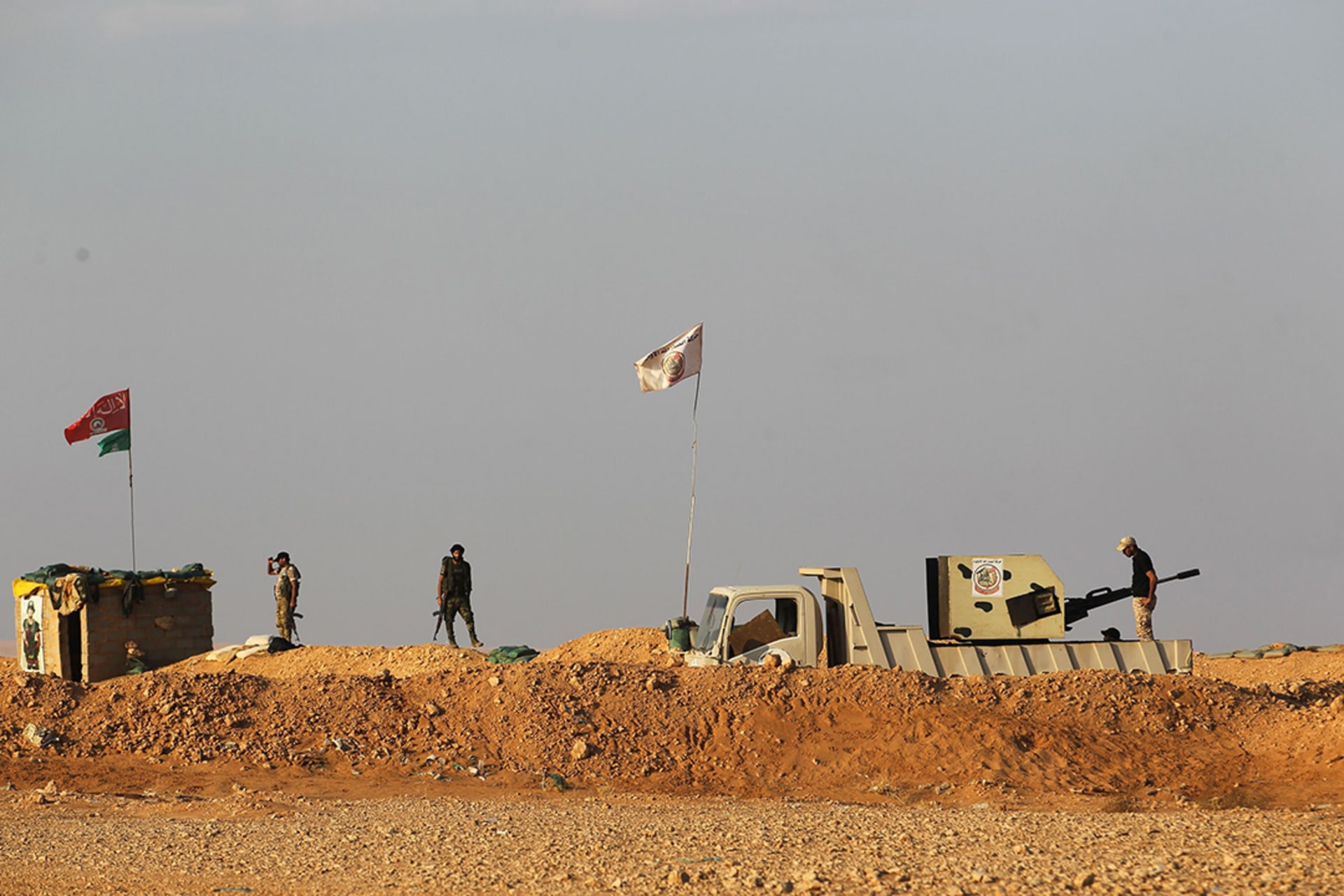 Iraqi Shiite fighters of the Hashed al-Shaabi paramilitary force stand guard on the border area with Syria.
