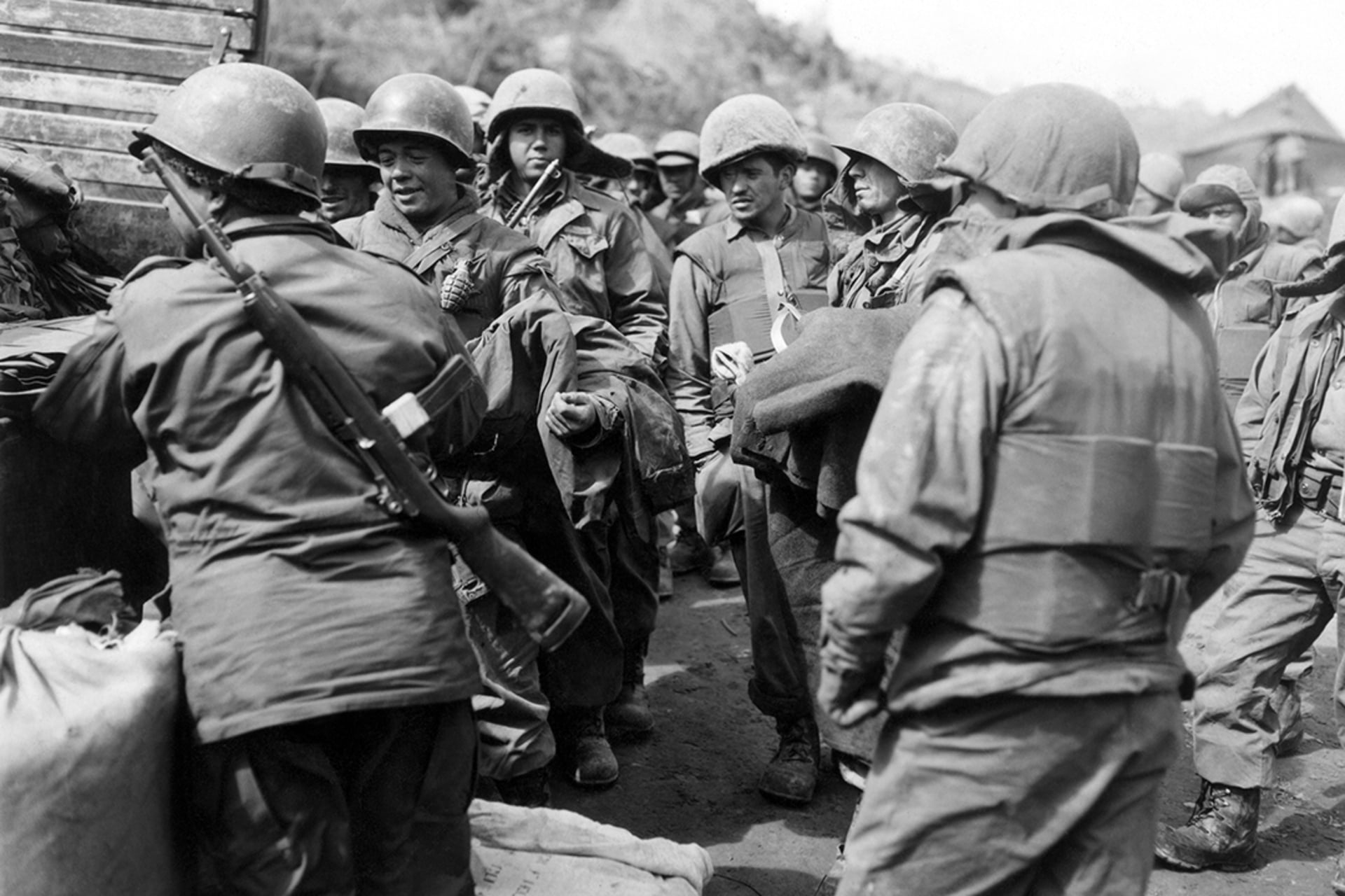 Colombian soldiers receive rations and equipment alongside their U.S. counterparts during the Korean War in March 1953. George Sweers/AP Images