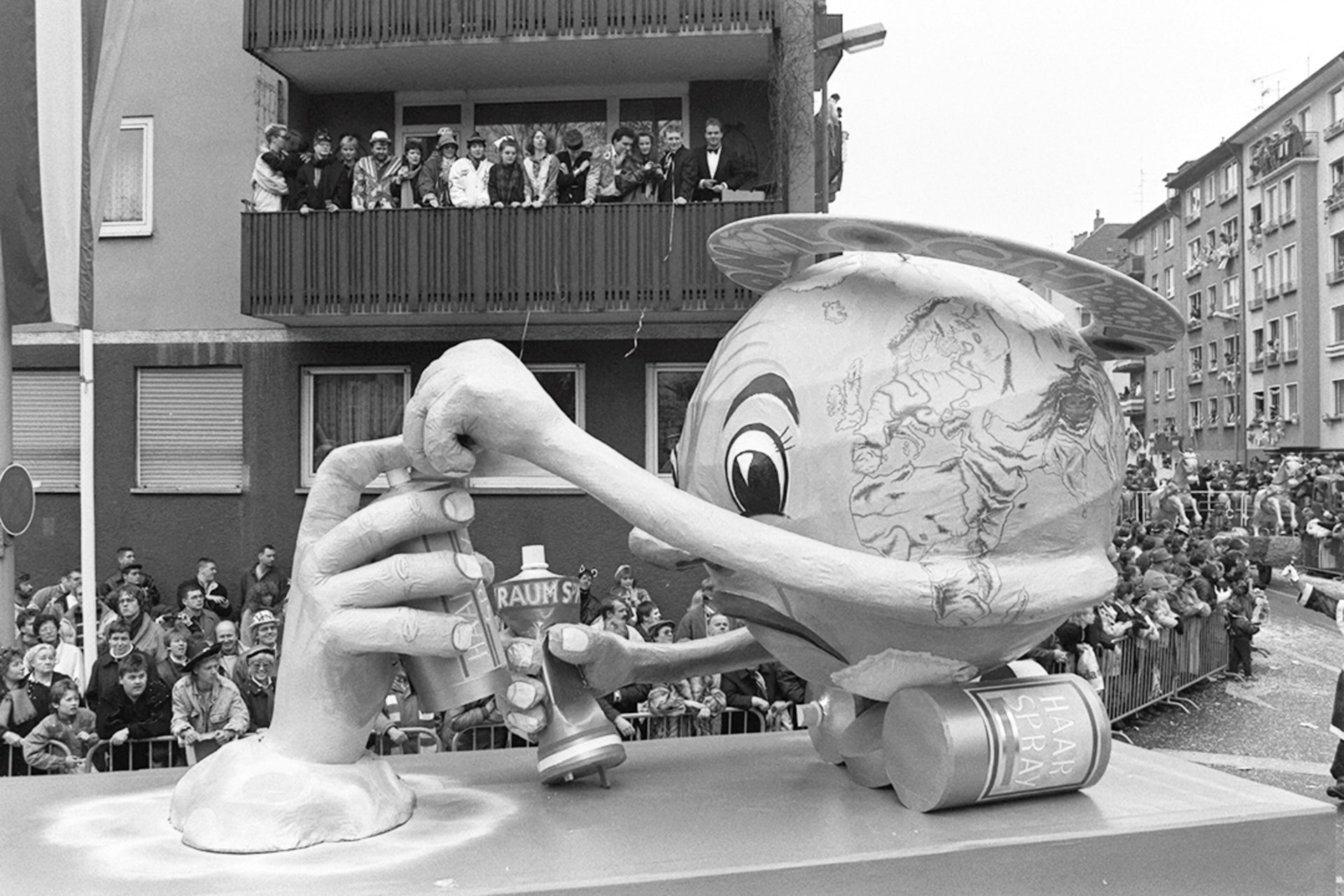 An effigy of Earth trying to grab aerosol cans from a hand polluting the planet rolls down the street during a carnival in Mainz, Germany, February 6, 1989. Mauritz Antin/Reuters