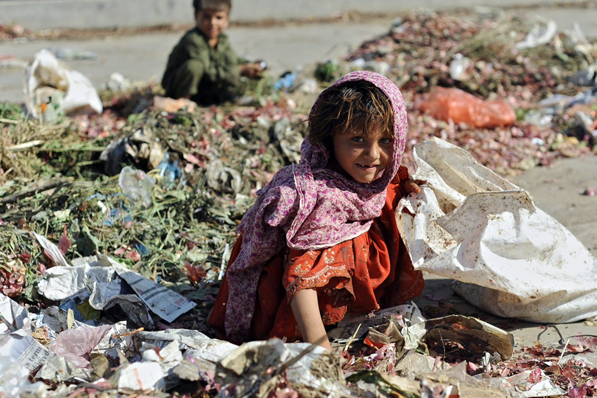 A Pakistani girl collects food from a garbage dump in Islamabad as UNICEF calls for greater global action on child labor, June 12, 2010. Farooq Naeem/AFP/Getty Images