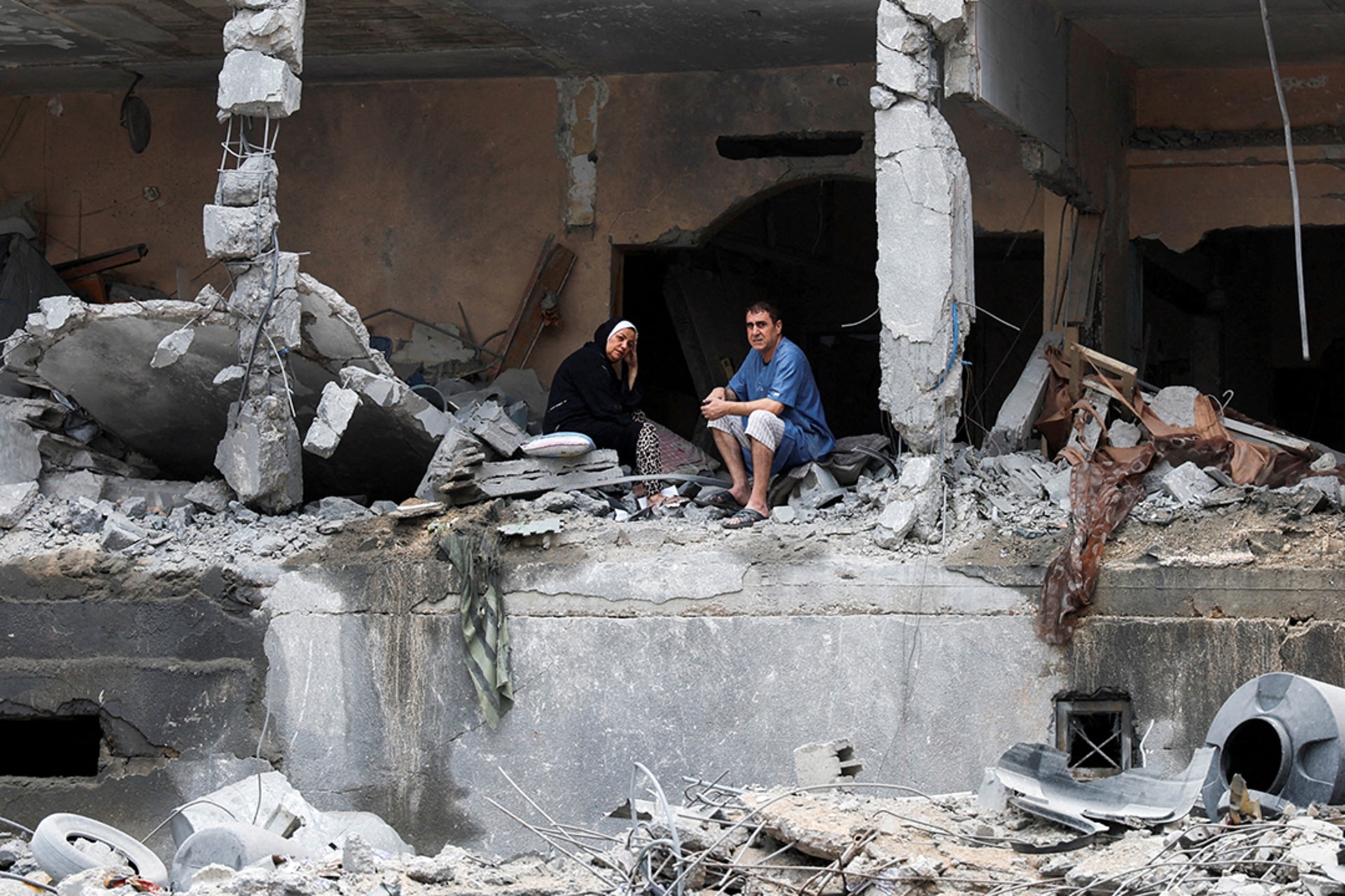 Palestinians sit on the rubble of a damaged building in Gaza City in the aftermath of Israeli strikes, October 10, 2023. Mohammed Salem/Reuters
