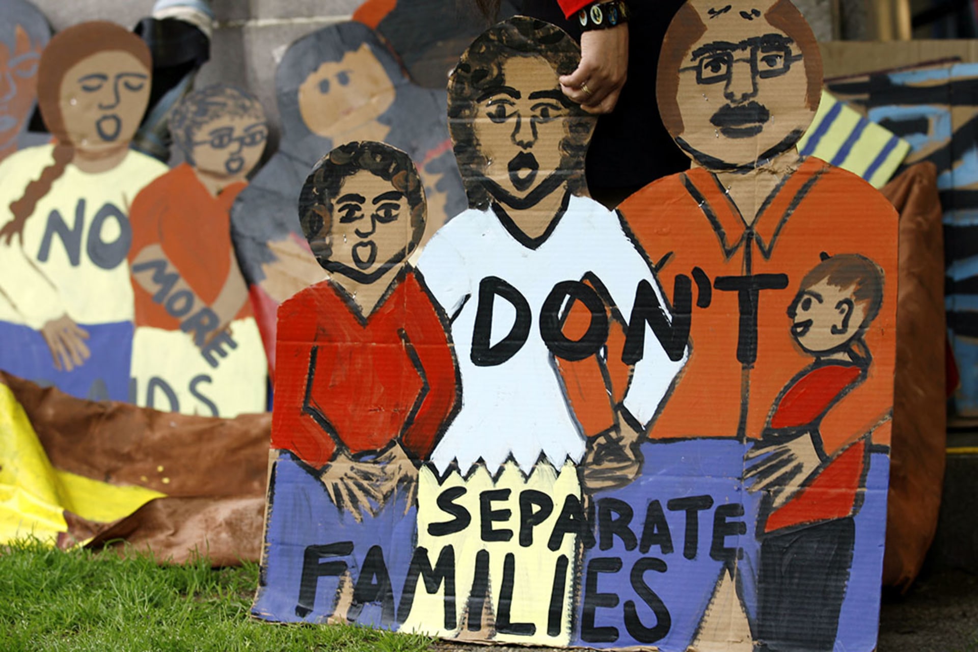 Protesters hold a banner during an immigration rights demonstration against raids and deportations of undocumented immigrants. Jose Luis Magana/AP