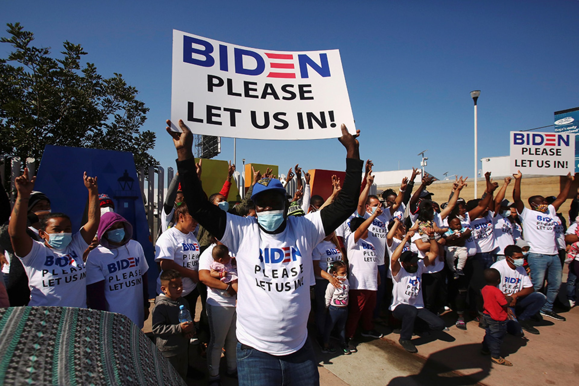 Migrants seeking asylum in the United States appeal to U.S. President Joe Biden at their campsite near the Tijuana border crossing in February 2021. Jorge Duenes/Reuters