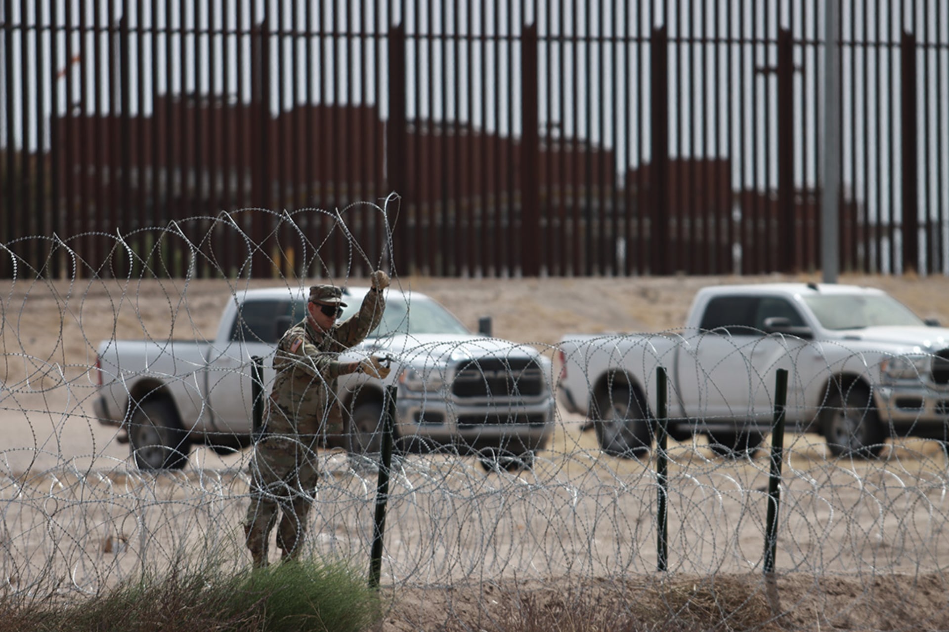 A member of the Texas National Guard puts up fencing along the U.S.-Mexico border to prepare for a surge in migration that is expected after Title 42 ends. Christian Torres Chavez/Anadolu Agency/Getty Images
